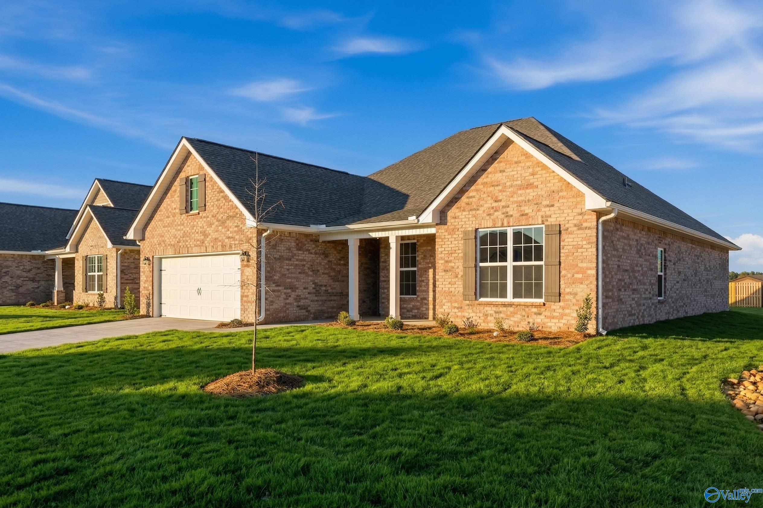 Brick ranch home with gabled roof, 2-car garage, and covered porch in Creekside, Harvest, Alabama by Davidson Homes
