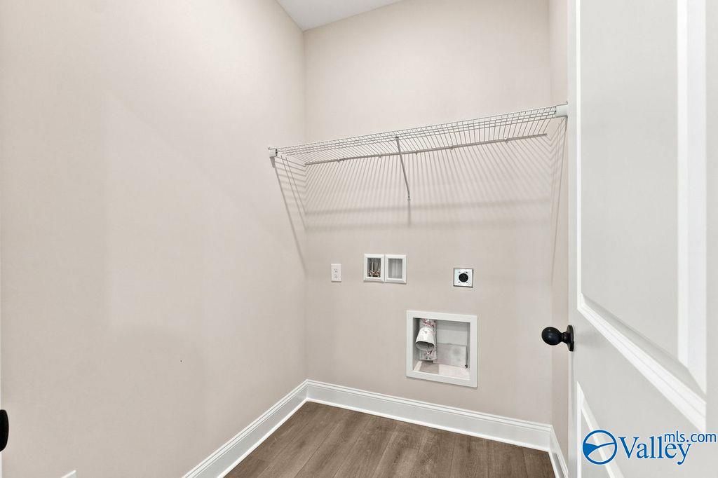 Laundry room with wire shelving and utility hookups in The Camilla B floor plan at The Retreat at Cain Park, Hartselle.