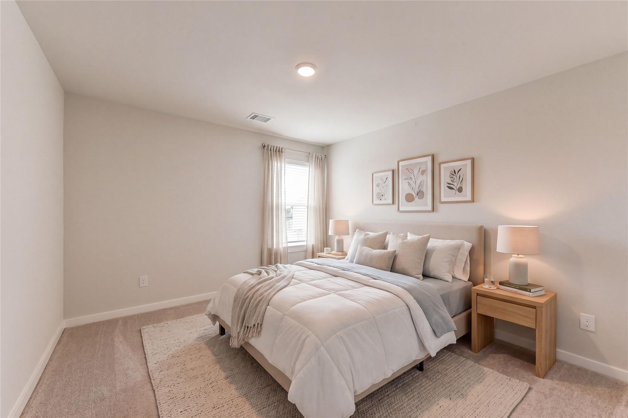 Serene bedroom with white duvet bed, beige walls, sheer curtains, and botanical art in Davidson Homes The Sabine F, Dayton, Texas