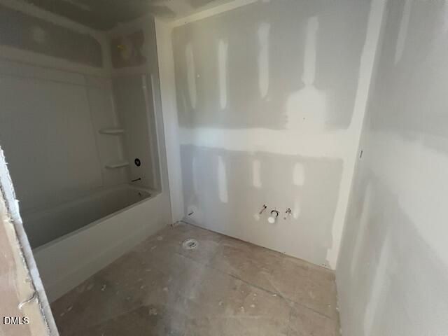 Unfinished bathroom with tub shower combo and drywall under construction in Davidson Homes The Ash C plan, Lillington, NC
