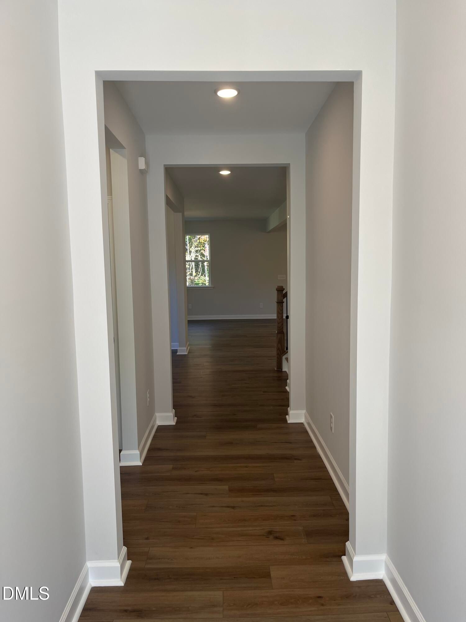 Bright hallway with luxury vinyl plank flooring leading to open living space in Davidson Homes Beech C plan, Wake Forest