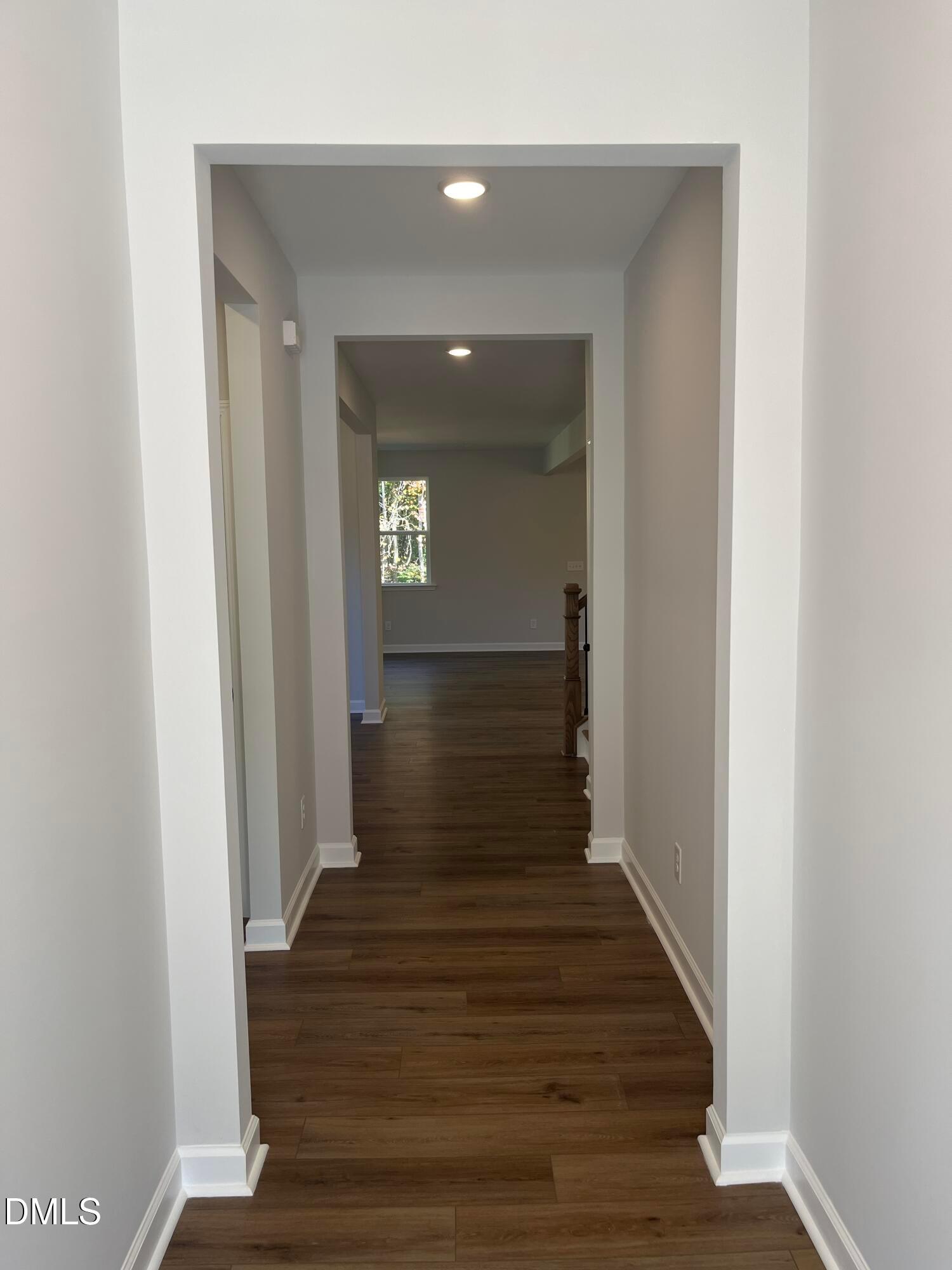 Bright hallway with luxury vinyl plank flooring leading to open living space in Davidson Homes Beech C plan, Wake Forest