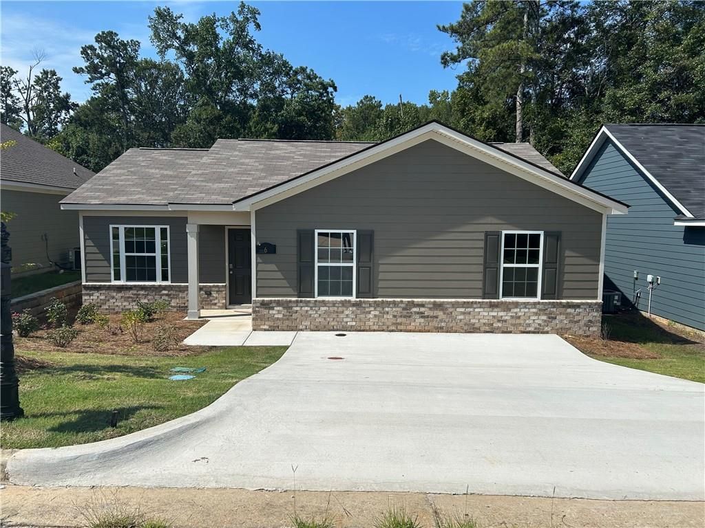 Modern gray single-story 3-bedroom home with brick base, shingled roof, and driveway in Summer Vineyard, Phenix City, Alabama