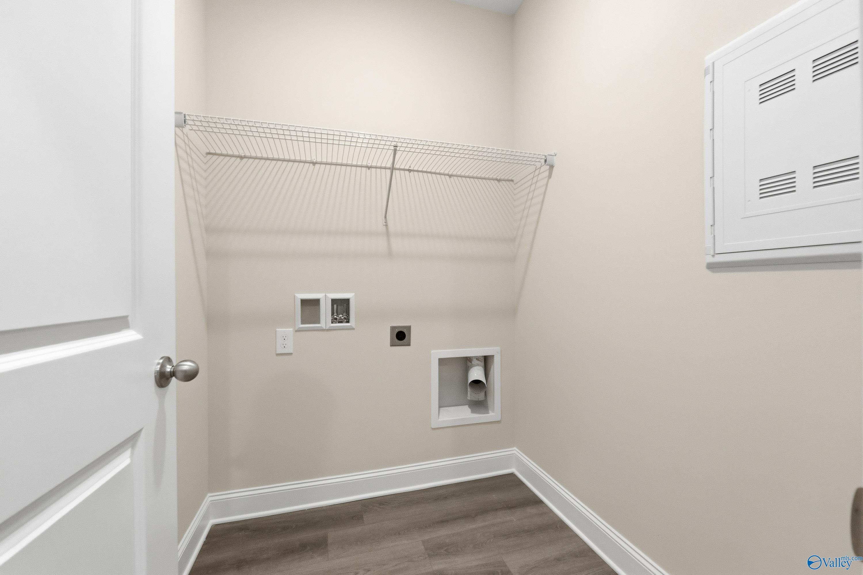 Functional laundry room with wire shelving, washer hookups and storage in Davidson Homes Asheville C, Huntsville AL
