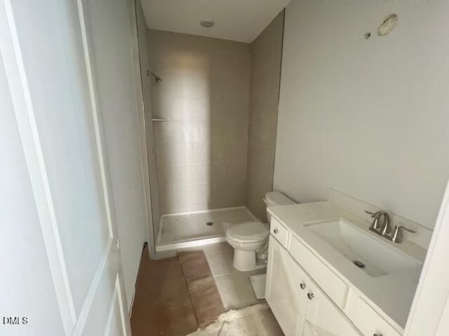 Bright modern bathroom with white vanity, glass shower enclosure, and beige tile in Davidson Homes Adalynn B, Lillington, NC