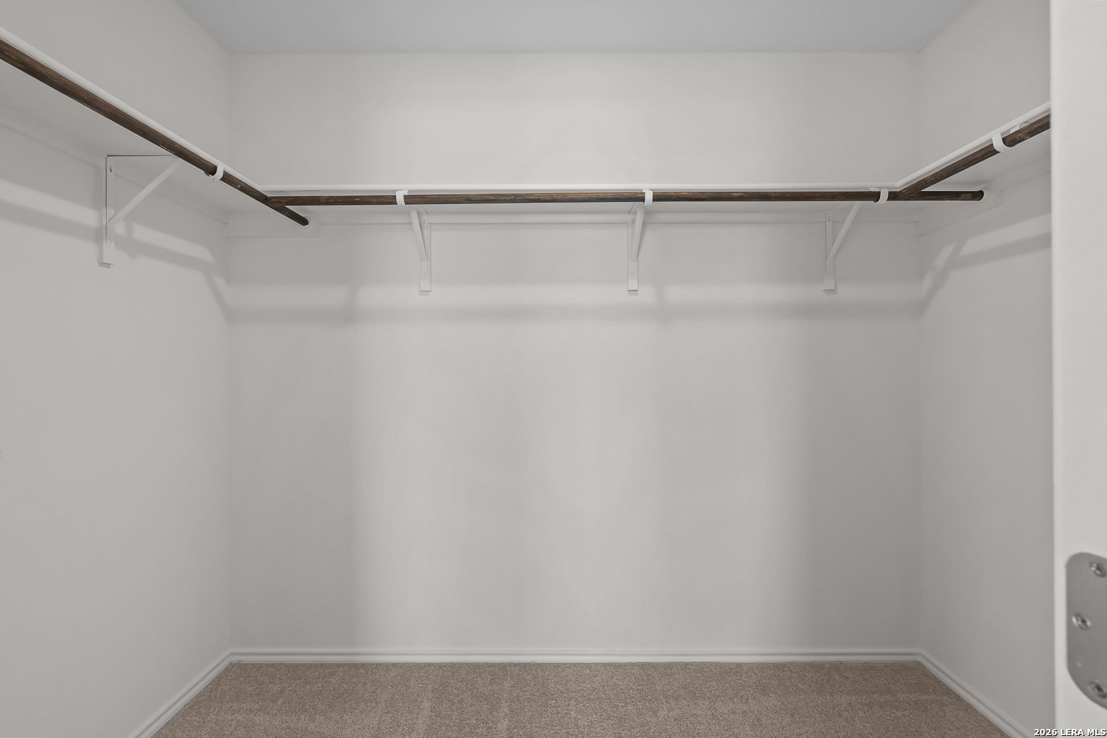 Spacious walk-in closet with built-in shelving in The Gillian C floor plan at Meadows at Oak Creek, San Antonio, Texas.