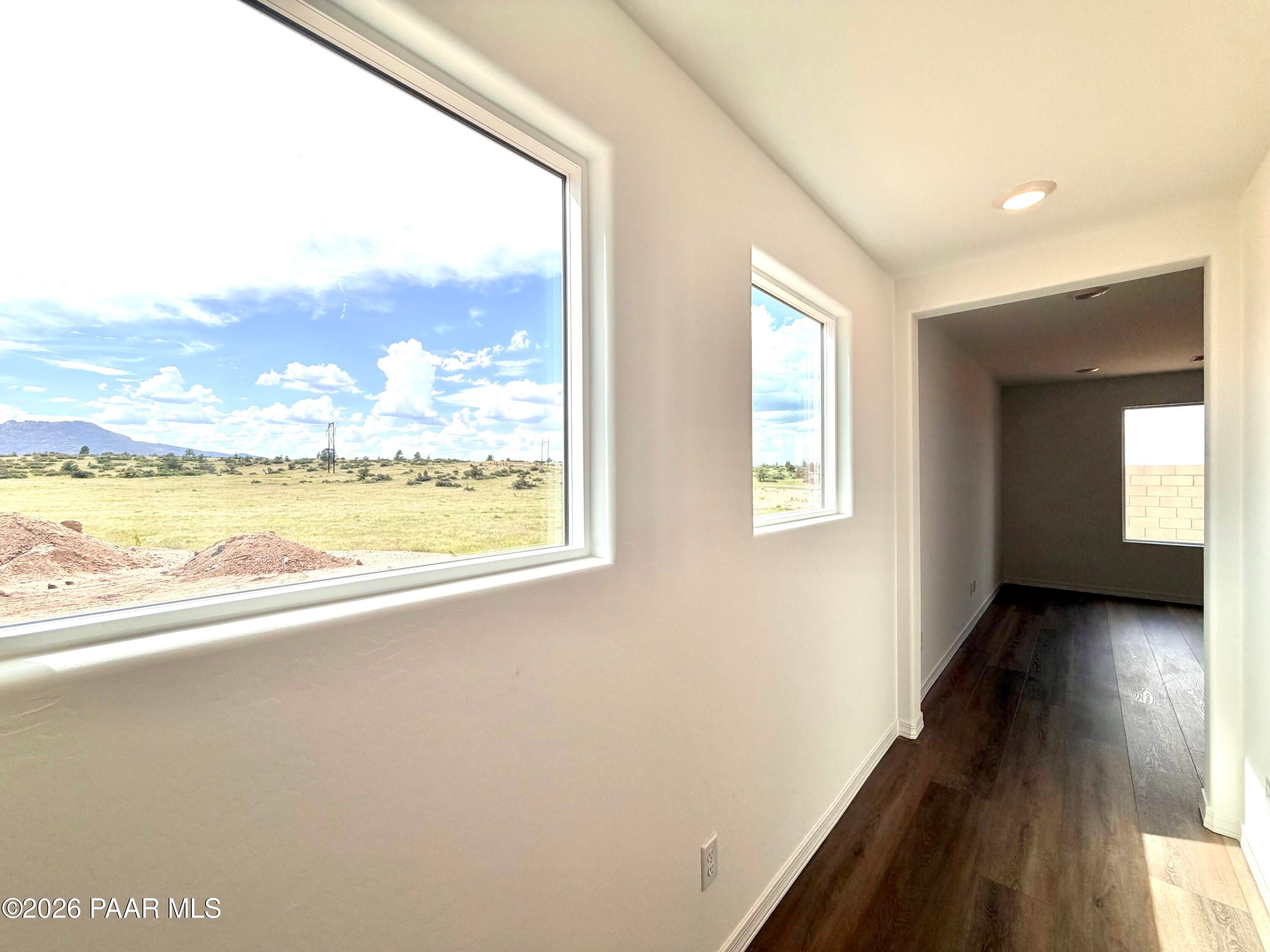 Large windows with scenic landscape views in The Raleigh A floor plan at South Ranch Southern Collection, Prescott, Arizona.