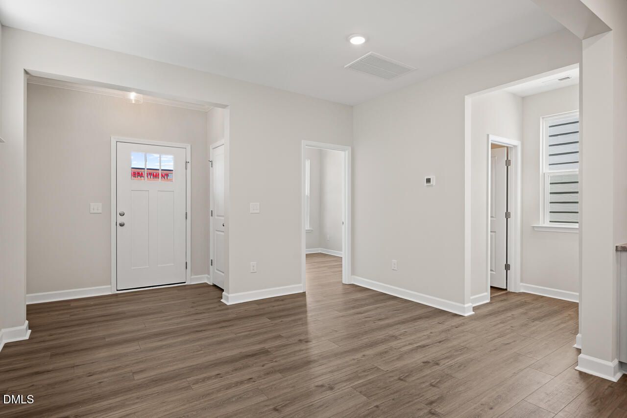 Bright entryway with wood-style flooring in The Alexander C floor plan by Davidson Homes in Forestville Yard, Knightdale.