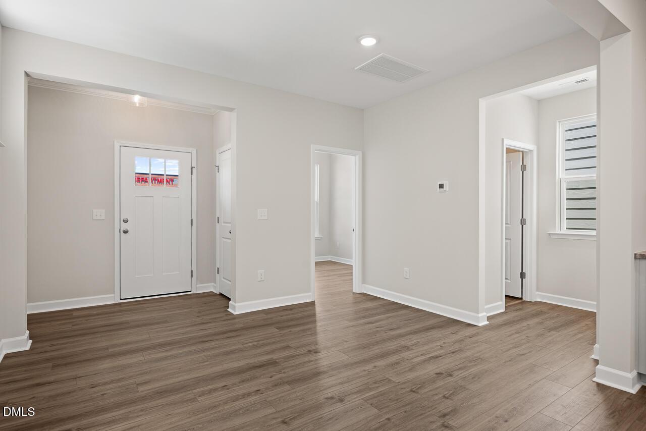 Bright entryway with wood-style flooring in The Alexander C floor plan by Davidson Homes in Forestville Yard, Knightdale.