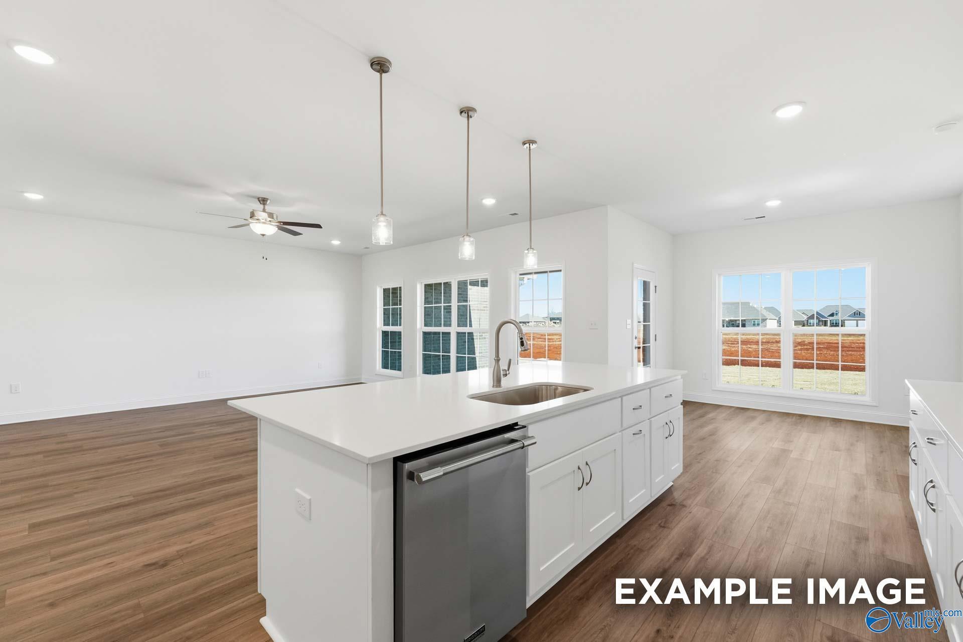 Open-concept kitchen with large island in The Valencia floor plan by Davidson Homes in Briercreek, Meridianville, Alabama.