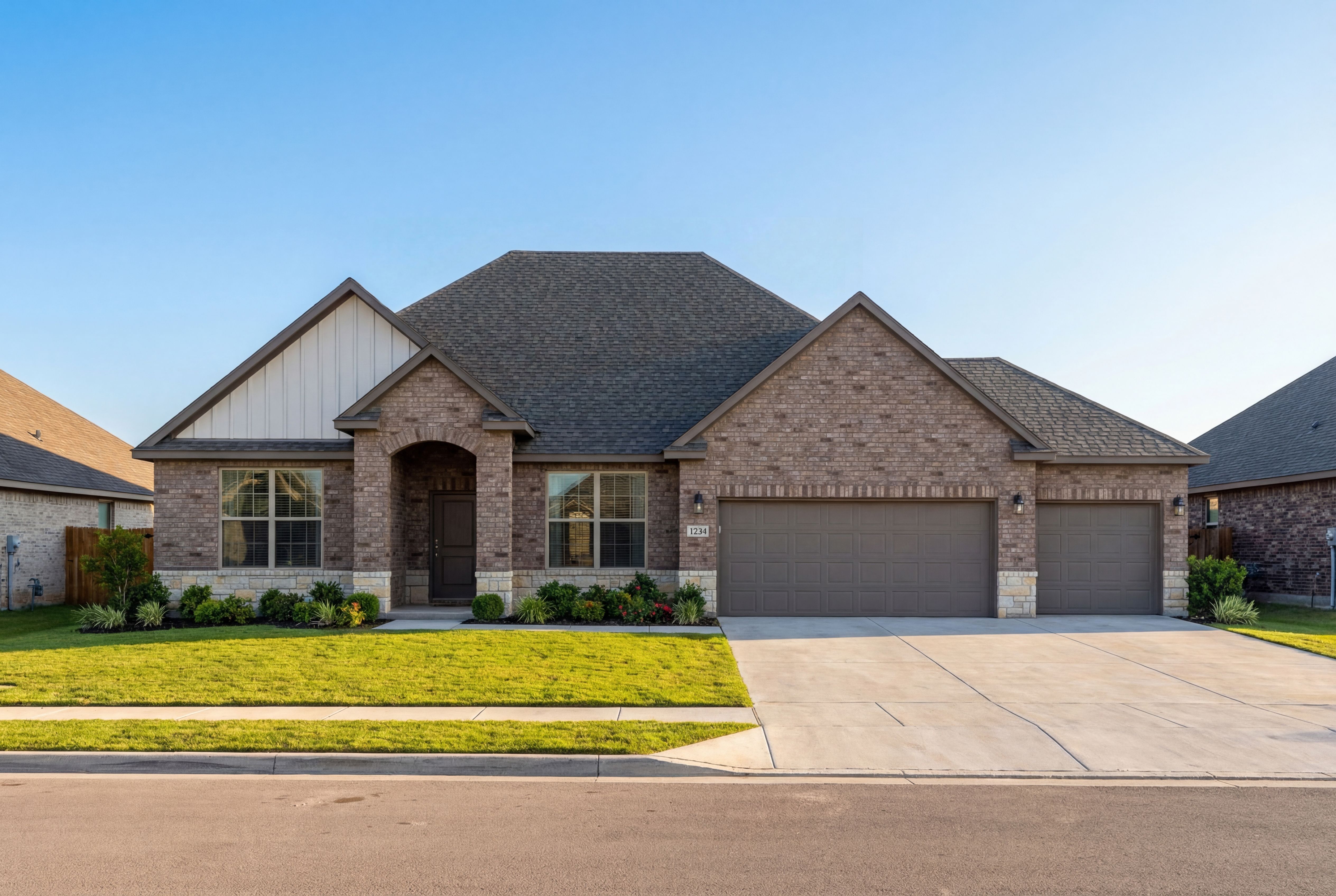 Modern single-story The Harrison D exterior with brick and siding, 3-car garage, arched entry, and lush green lawn