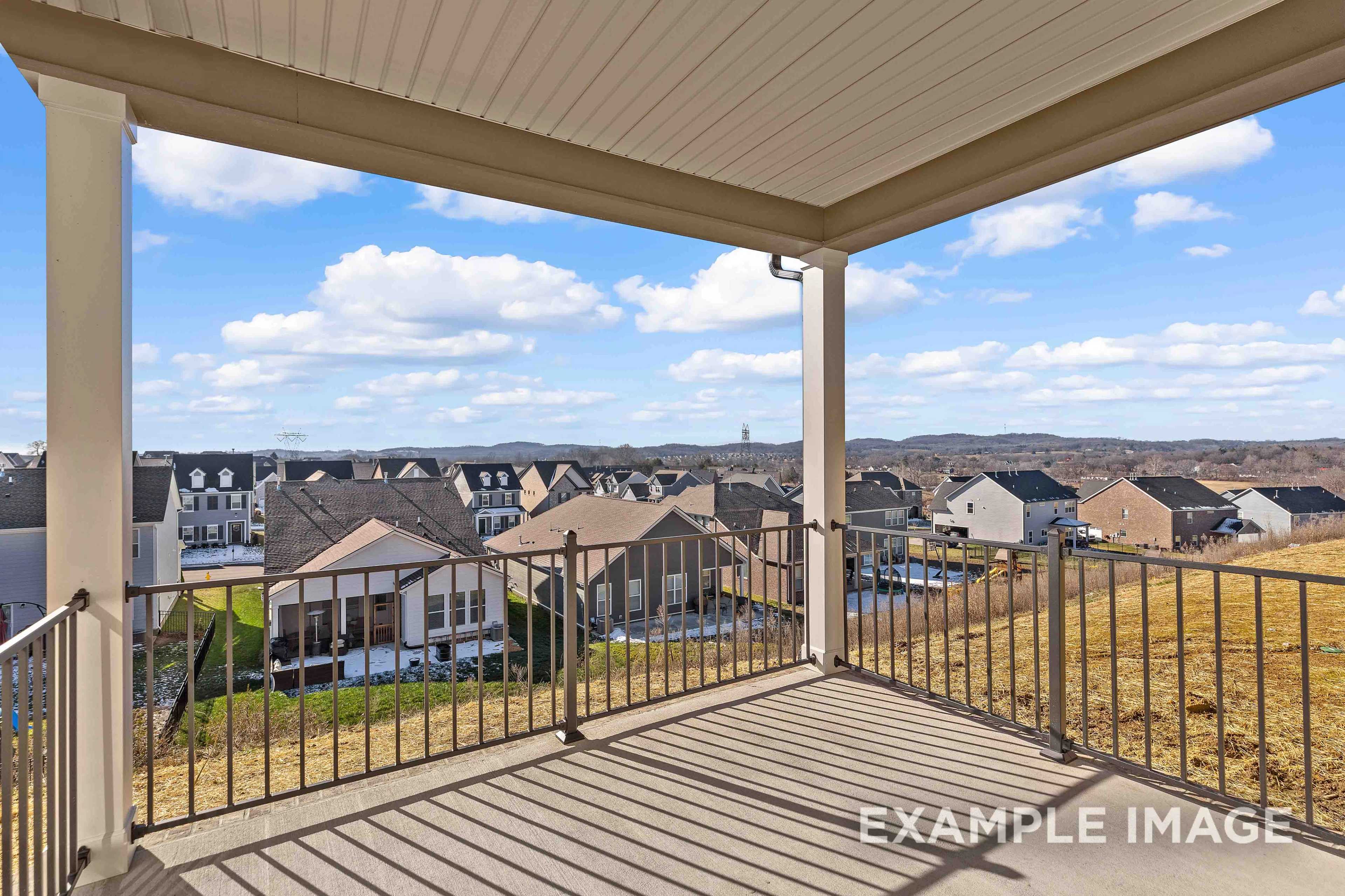 Spacious upper porch of The Willow C home overlooking Mt. Juliet neighborhood with townhomes and hills