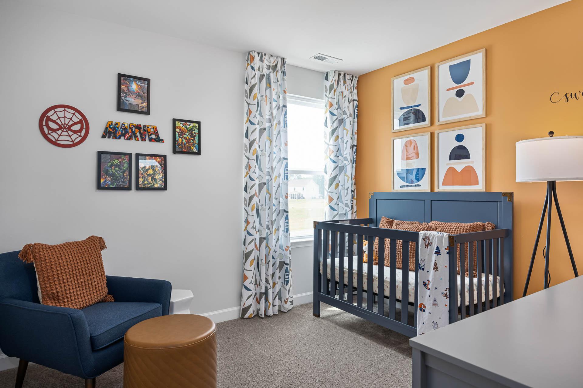 Nursery with navy crib and Marvel decor at Gregory Village in Lillington, NC by Davidson Homes.
