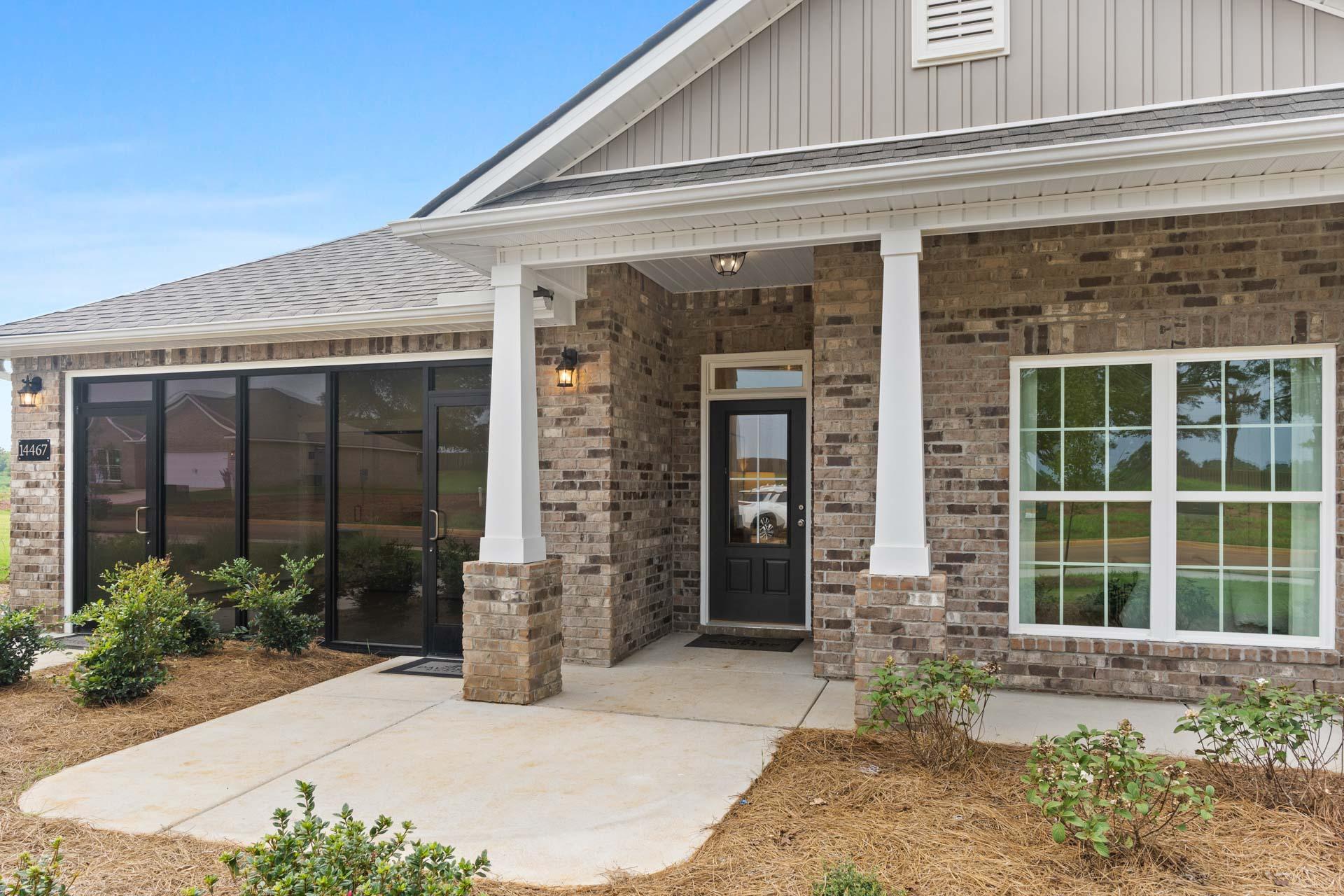 Modern craftsman home exterior at The Meadows in Athens Alabama with covered porch brick base and column accents