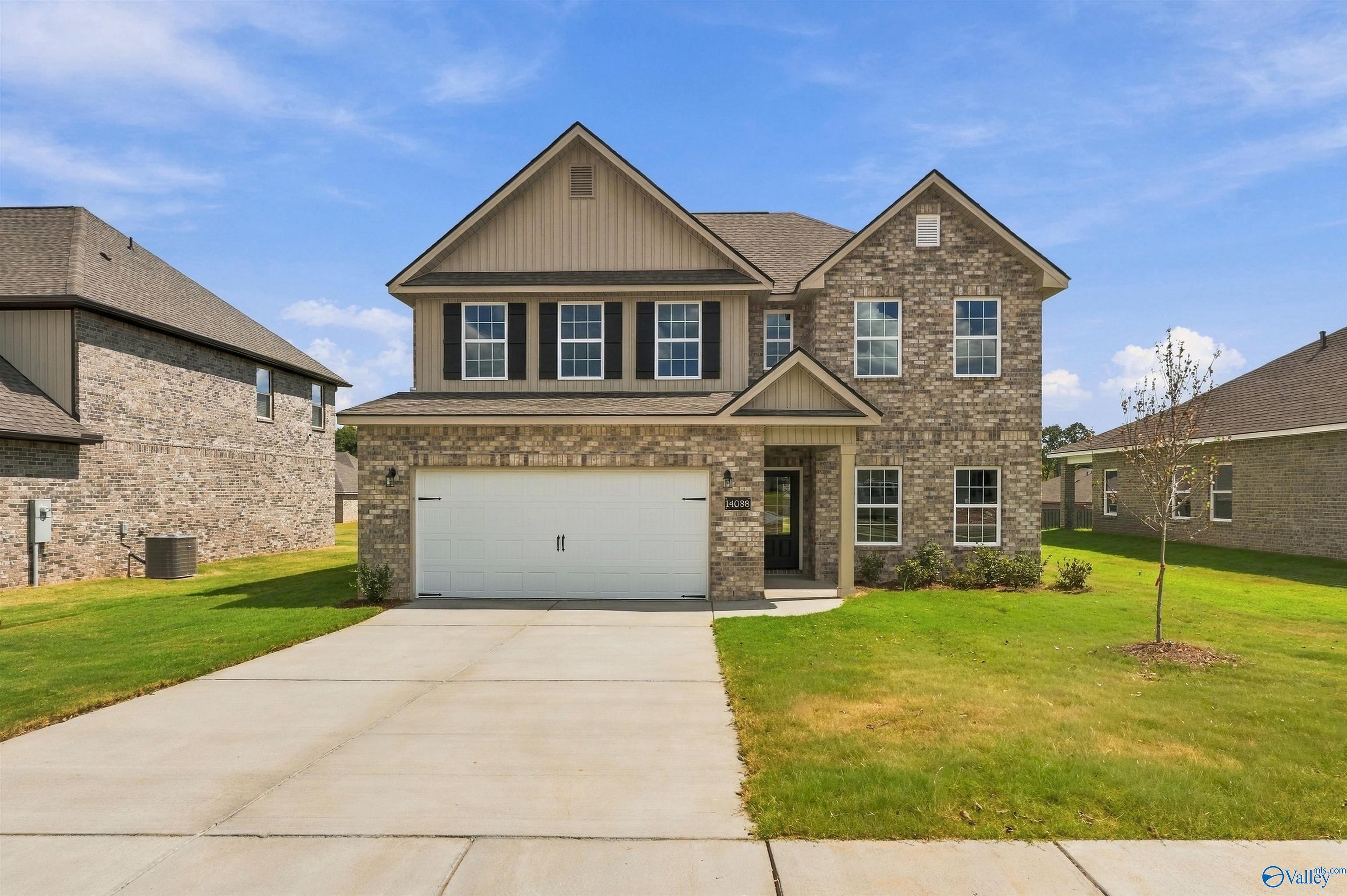 Two-story brick exterior of Davidson Homes' The Shelby A floor plan with 2-car garage in The Meadows, Athens, Alabama.