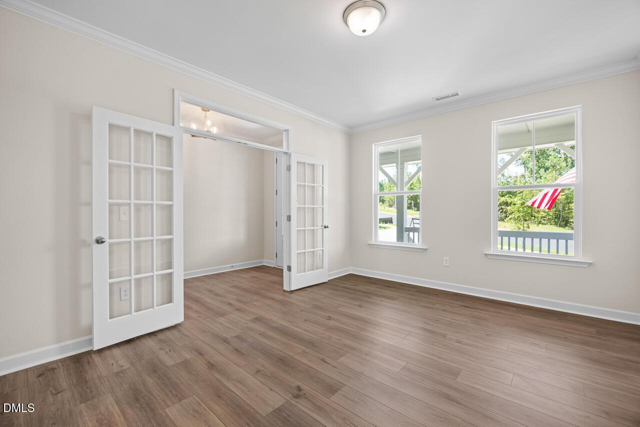 Bright home office with French doors and wood-look flooring in The Hickory II B floor plan, Montrose, Aberdeen, NC.