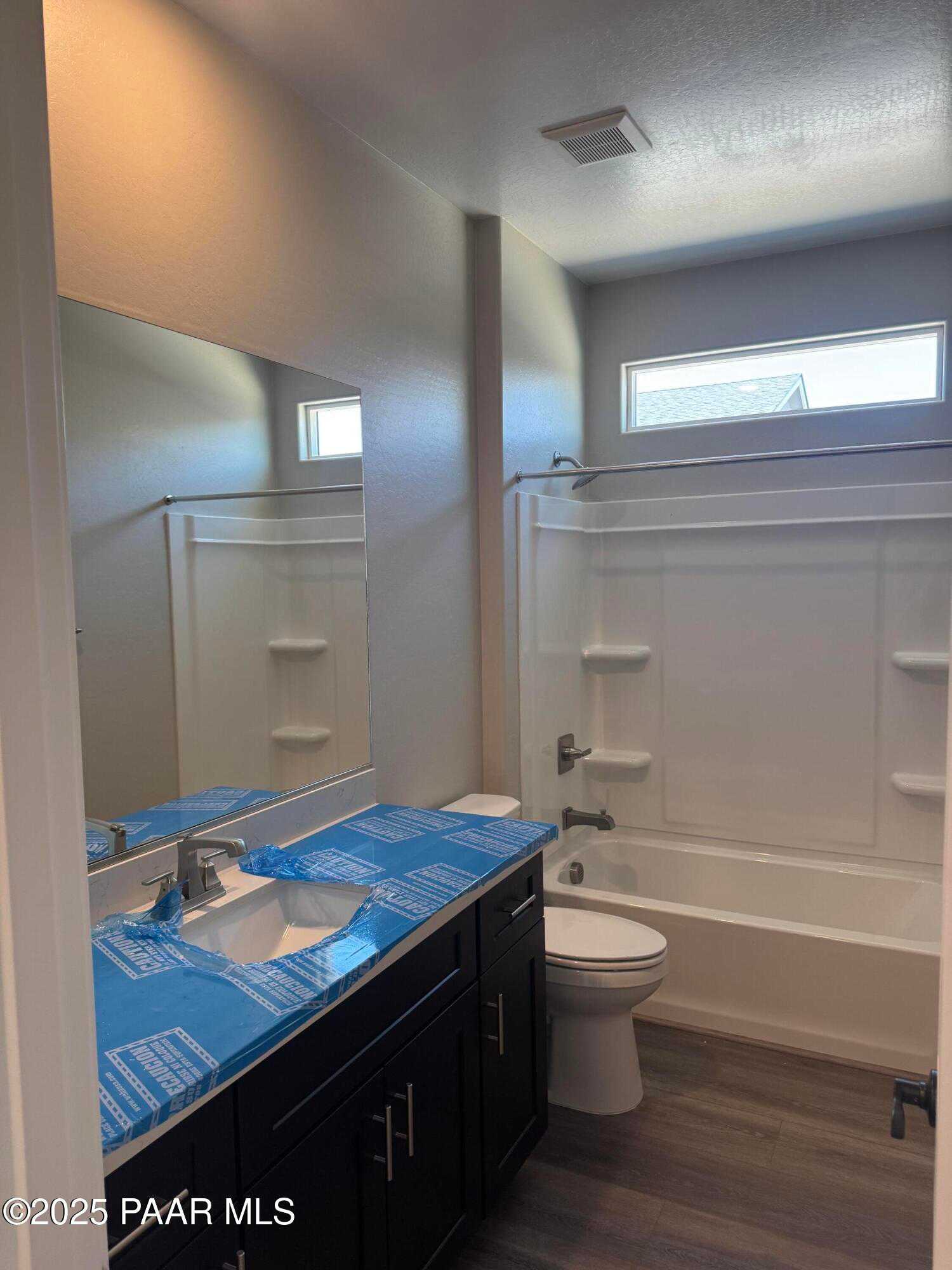 Modern bathroom with vanity, bathtub, walk-in shower, and large mirror in Davidson Homes The Durango II A, Prescott, AZ