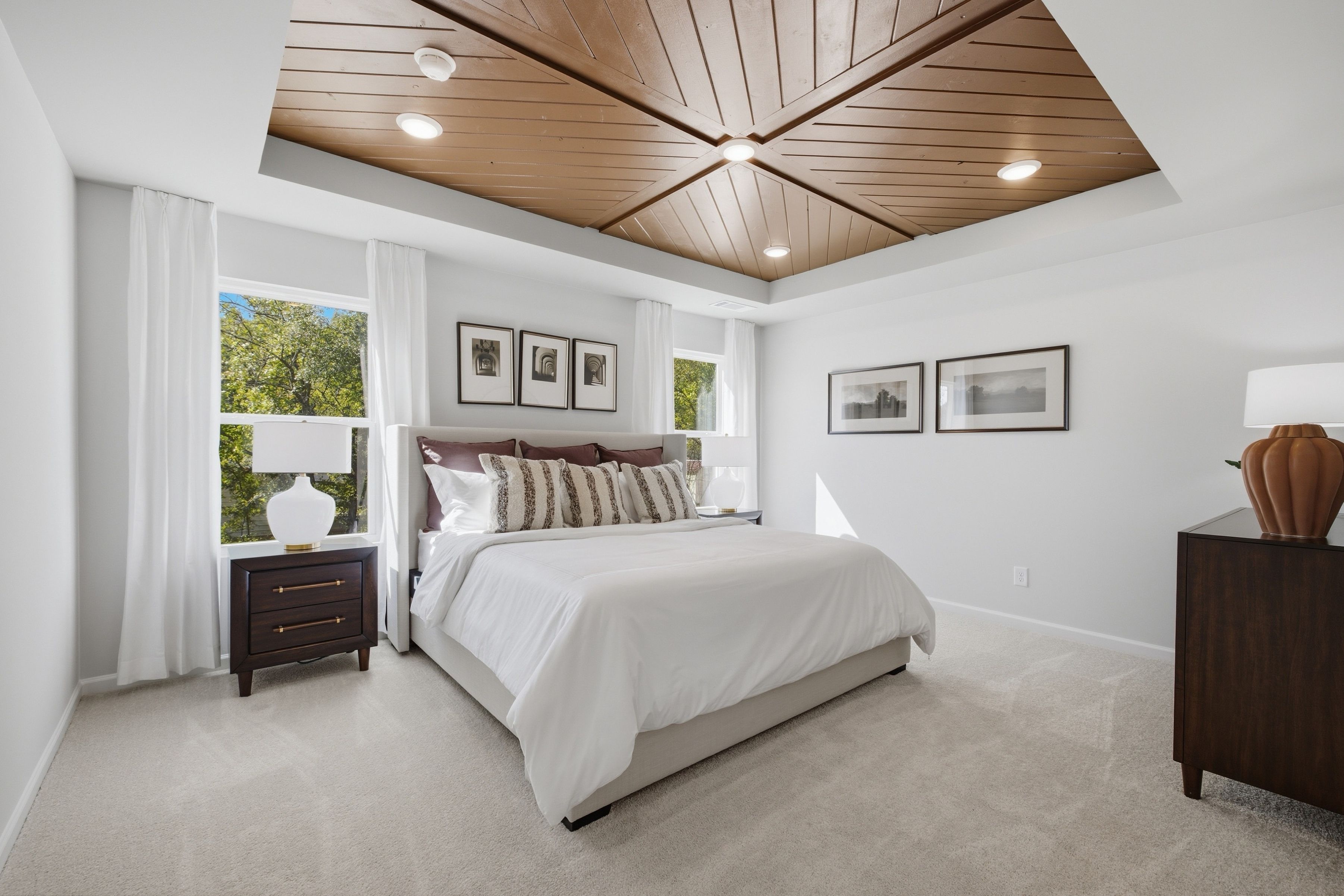 Primary bedroom with wood plank tray ceiling at Greene Farm by Davidson Homes in Cartersville, Georgia