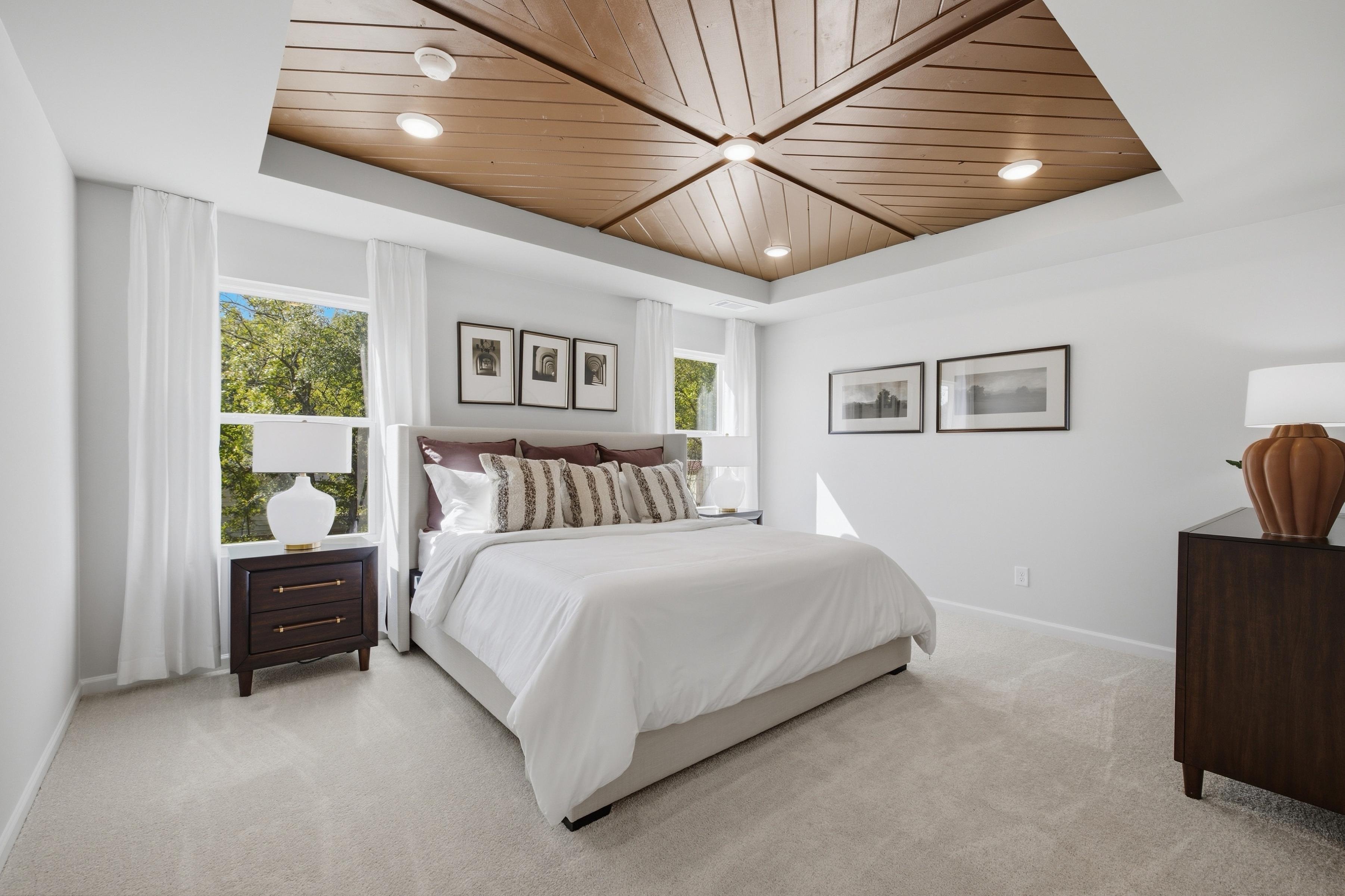 Primary bedroom with wood plank tray ceiling at Greene Farm by Davidson Homes in Cartersville, Georgia