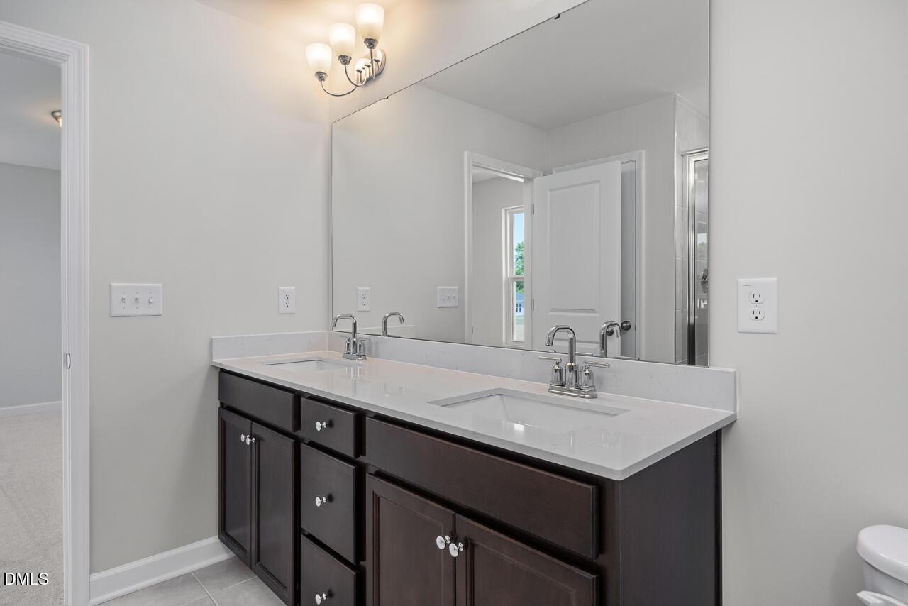 Double vanity with quartz countertops in The Grace C floor plan at Retreat at North Main in Lillington, North Carolina.