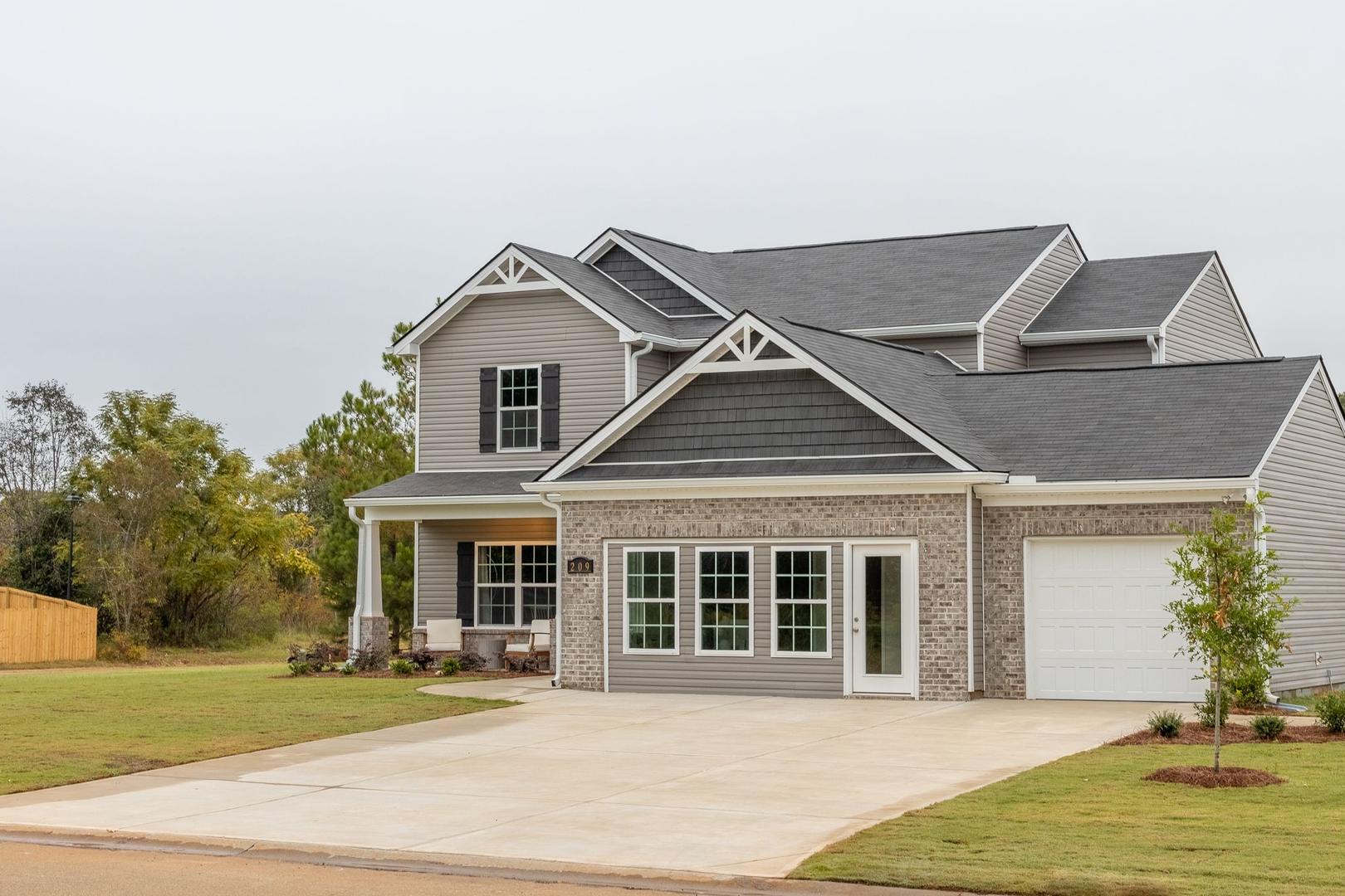 Modern two-story craftsman home exterior at Ivy Glen in Perry Georgia with covered front porch and attached garage