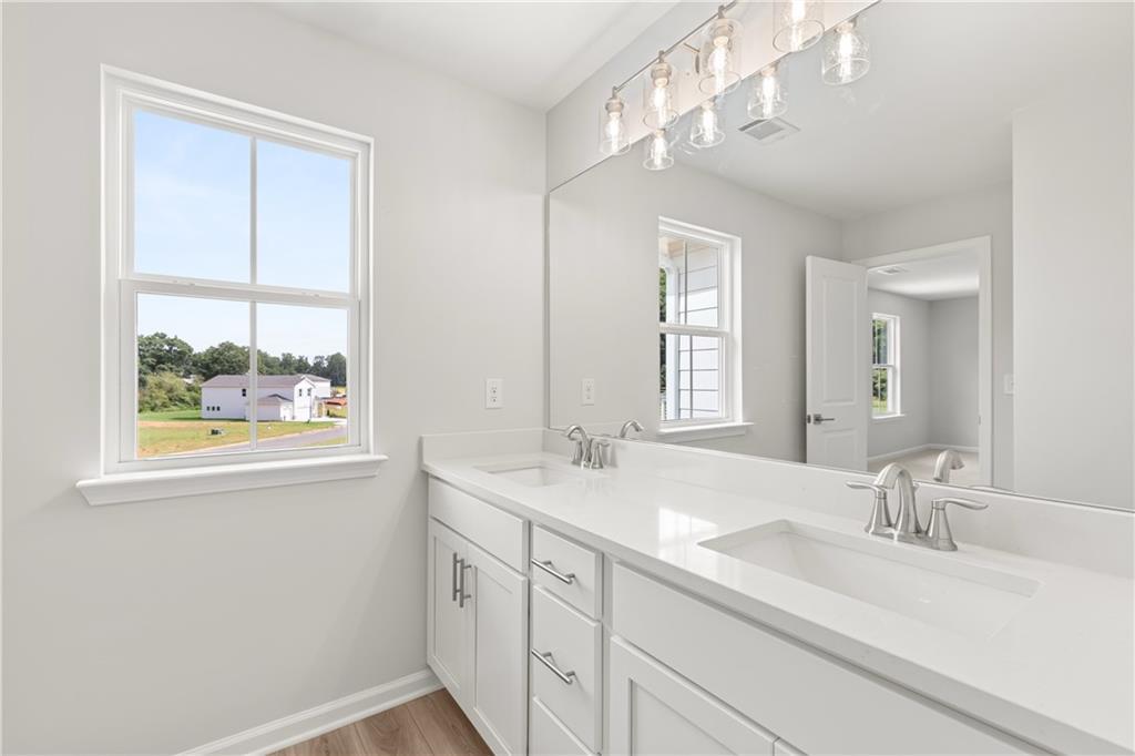 Modern double vanity with white cabinets and quartz countertops in The Russell A floor plan at Cedar Farms, Winder, GA.