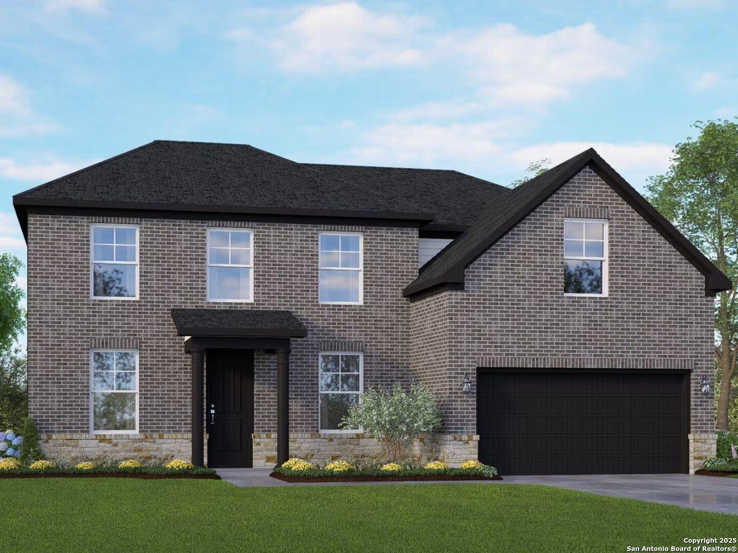 Two-story brick Danbury H home by Davidson Homes: black roof, two-car garage, front porch, landscaped yard in Castroville, Texas
