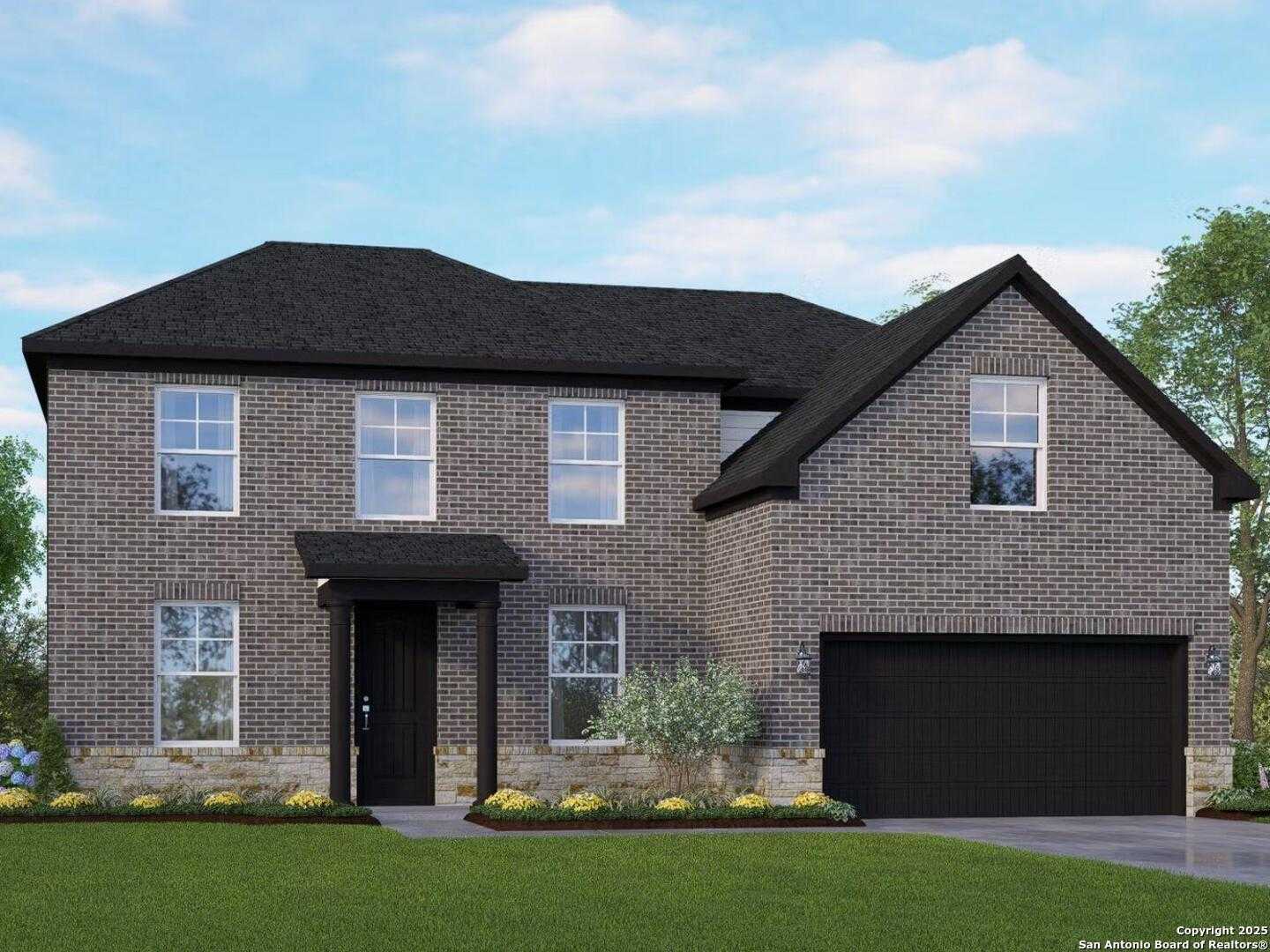 Two-story brick Danbury H home by Davidson Homes: black roof, two-car garage, front porch, landscaped yard in Castroville, Texas
