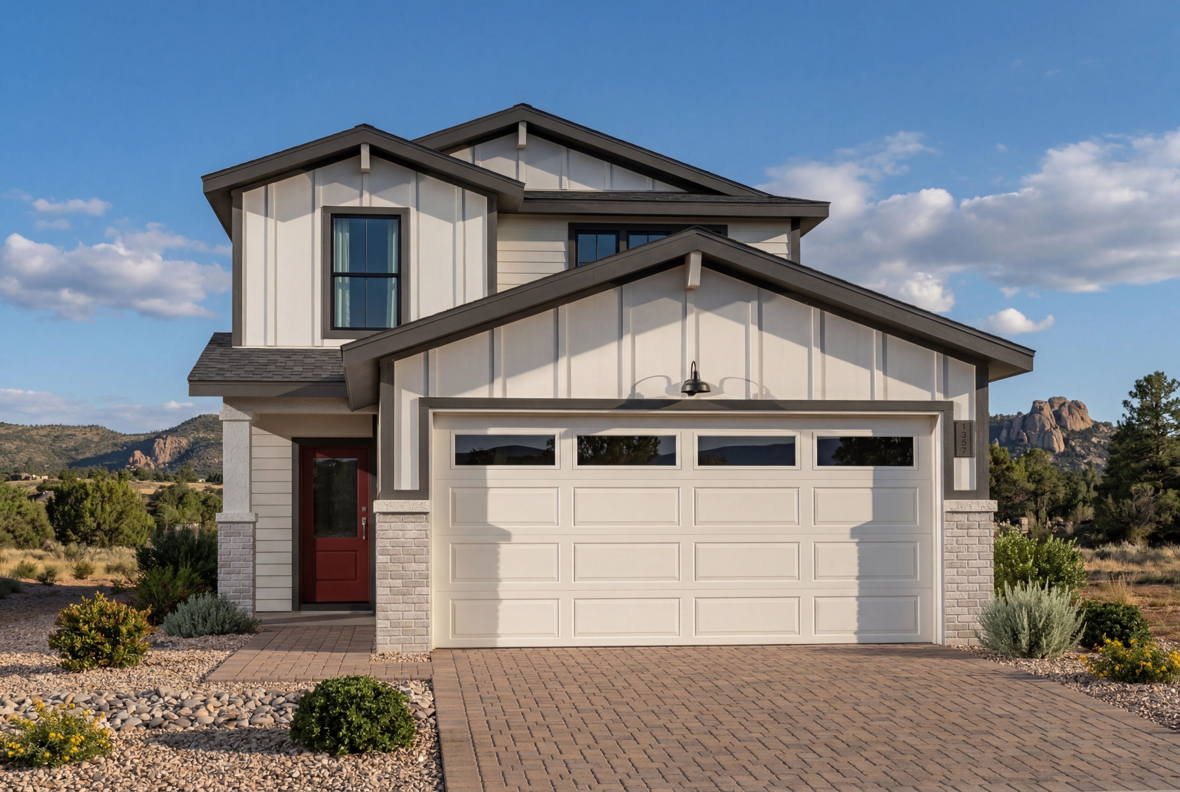 Modern farmhouse exterior of The Wilmington B in Prescott, Arizona, featuring white siding, stone accents, and a garage.