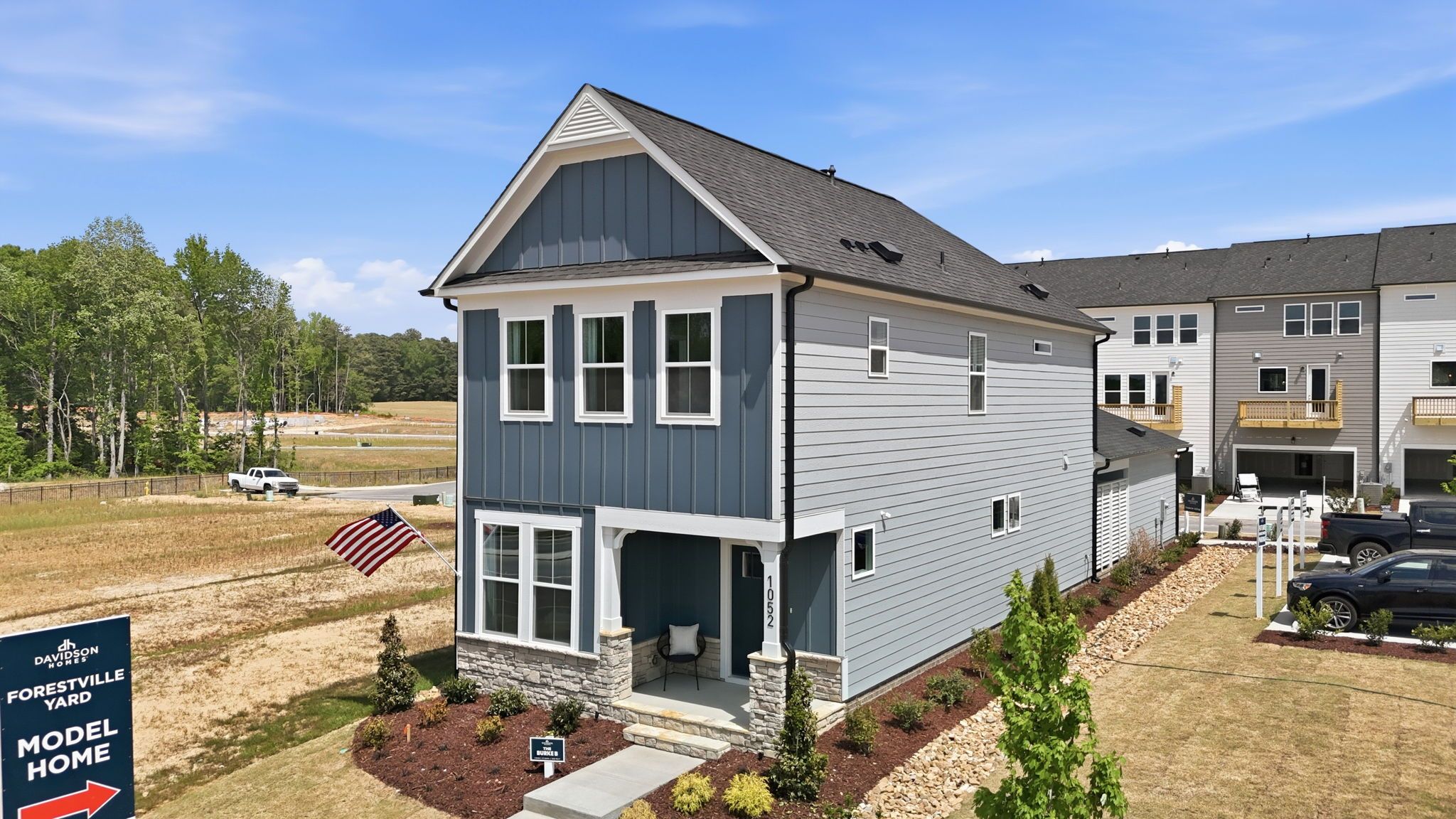 Two-story The Burke model home by Davidson Homes featuring a blue and gray siding exterior in Knightdale, North Carolina.