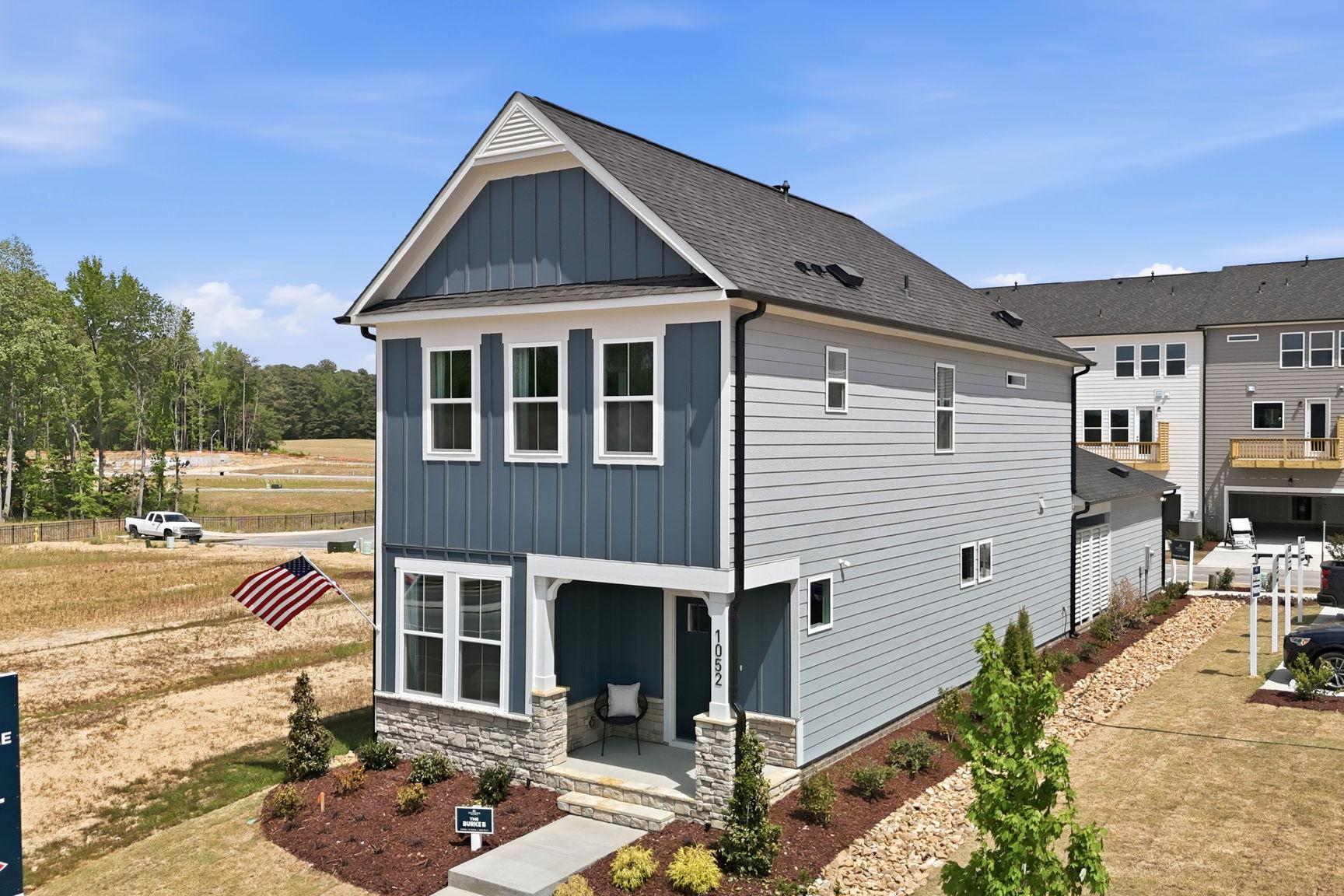Two-story The Burke model home by Davidson Homes featuring a blue and gray siding exterior in Knightdale, North Carolina.