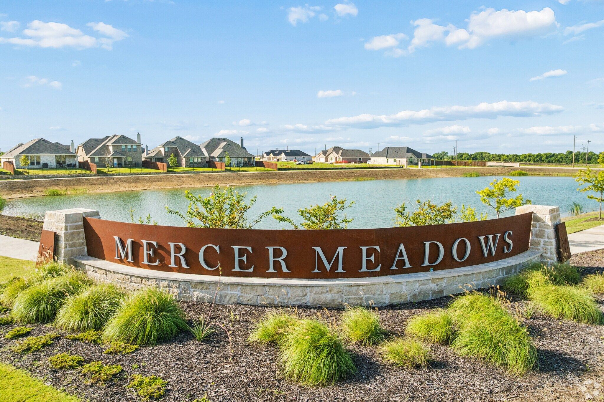 Stone and metal entrance sign for Mercer Meadows in Royse City, TX