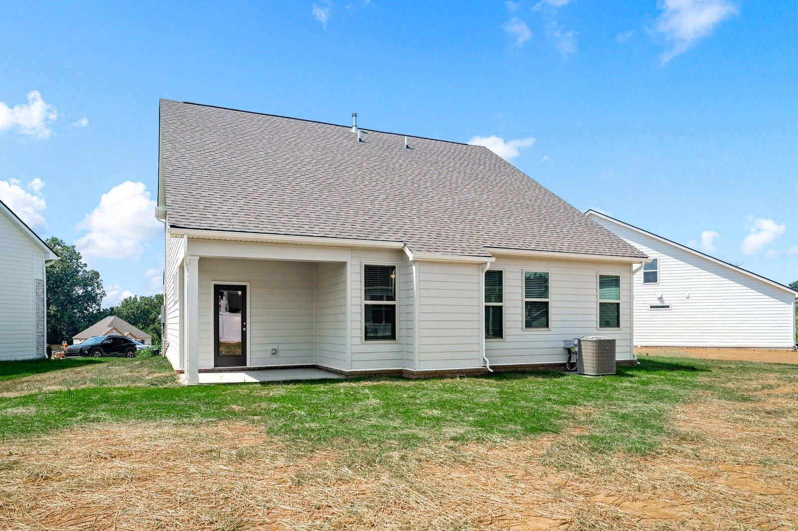 Back exterior of The Ash A floor plan by Davidson Homes in Woods Crossing, Gallatin, Tennessee with covered patio.