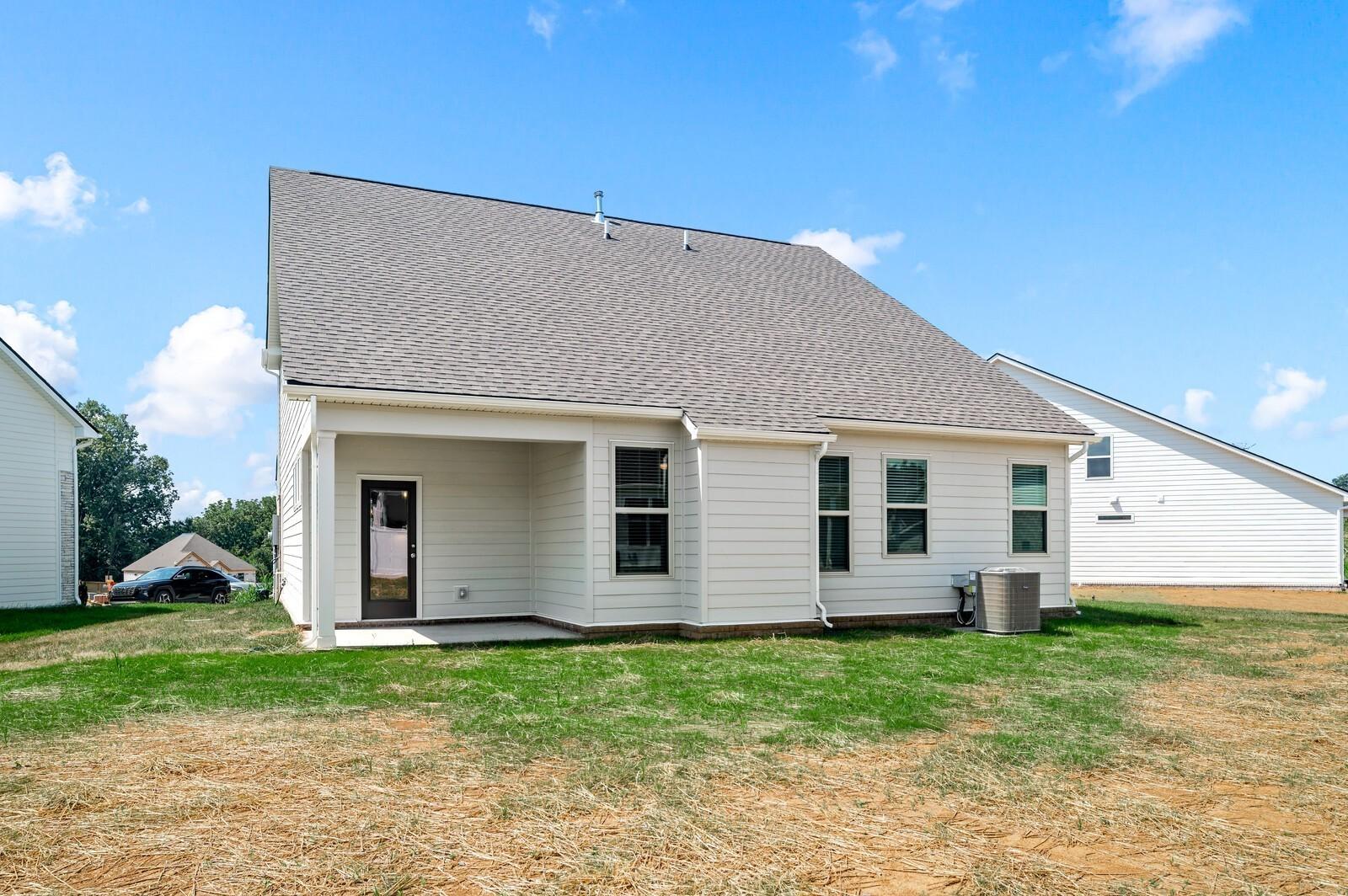 Back exterior of The Ash A floor plan by Davidson Homes in Woods Crossing, Gallatin, Tennessee with covered patio.