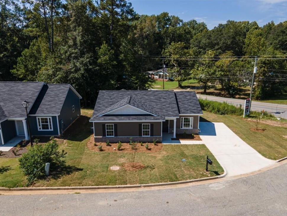 Modern 3-bedroom single-story home with dark roof, driveway, and landscaped yard in Summer Vineyard, Phenix City, Alabama by Davidson Homes
