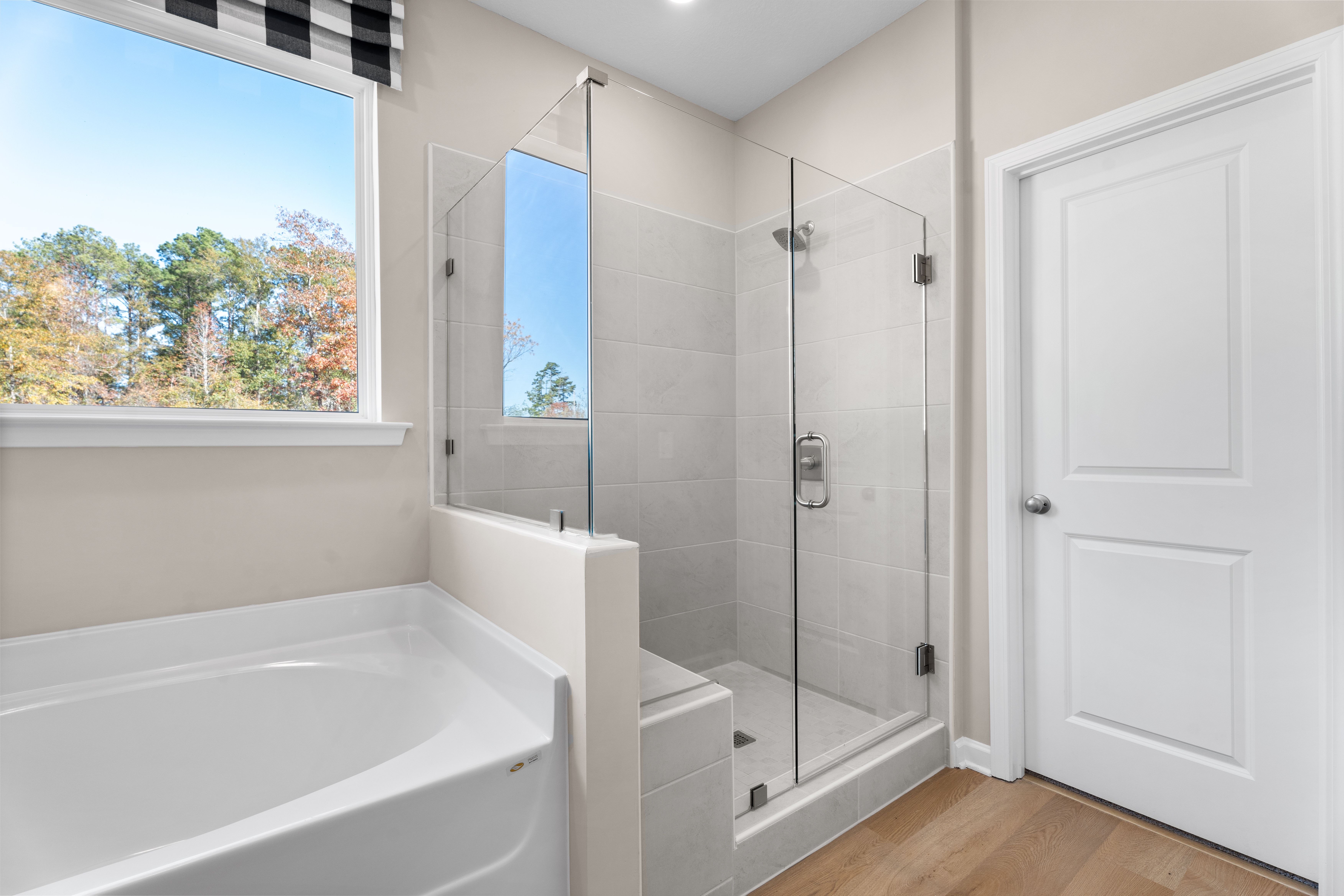 Modern master bathroom at Silver Oak in Cusseta Alabama with double vanity, dark cabinets, white sinks and framed wall art