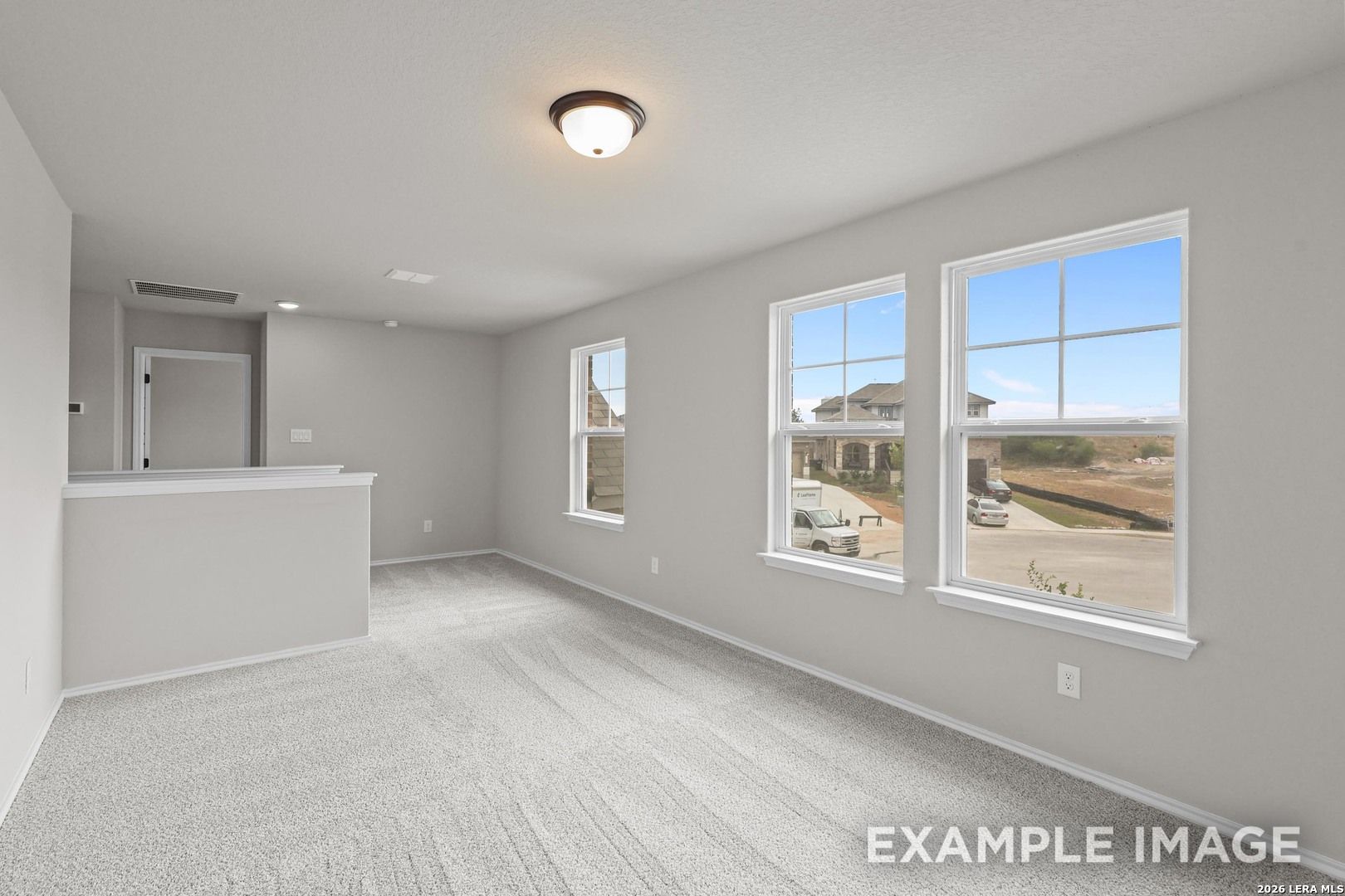 Bright upstairs game room with new carpet and neighborhood views in Davidson Homes The Murray H, Horizon Pointe, Converse TX