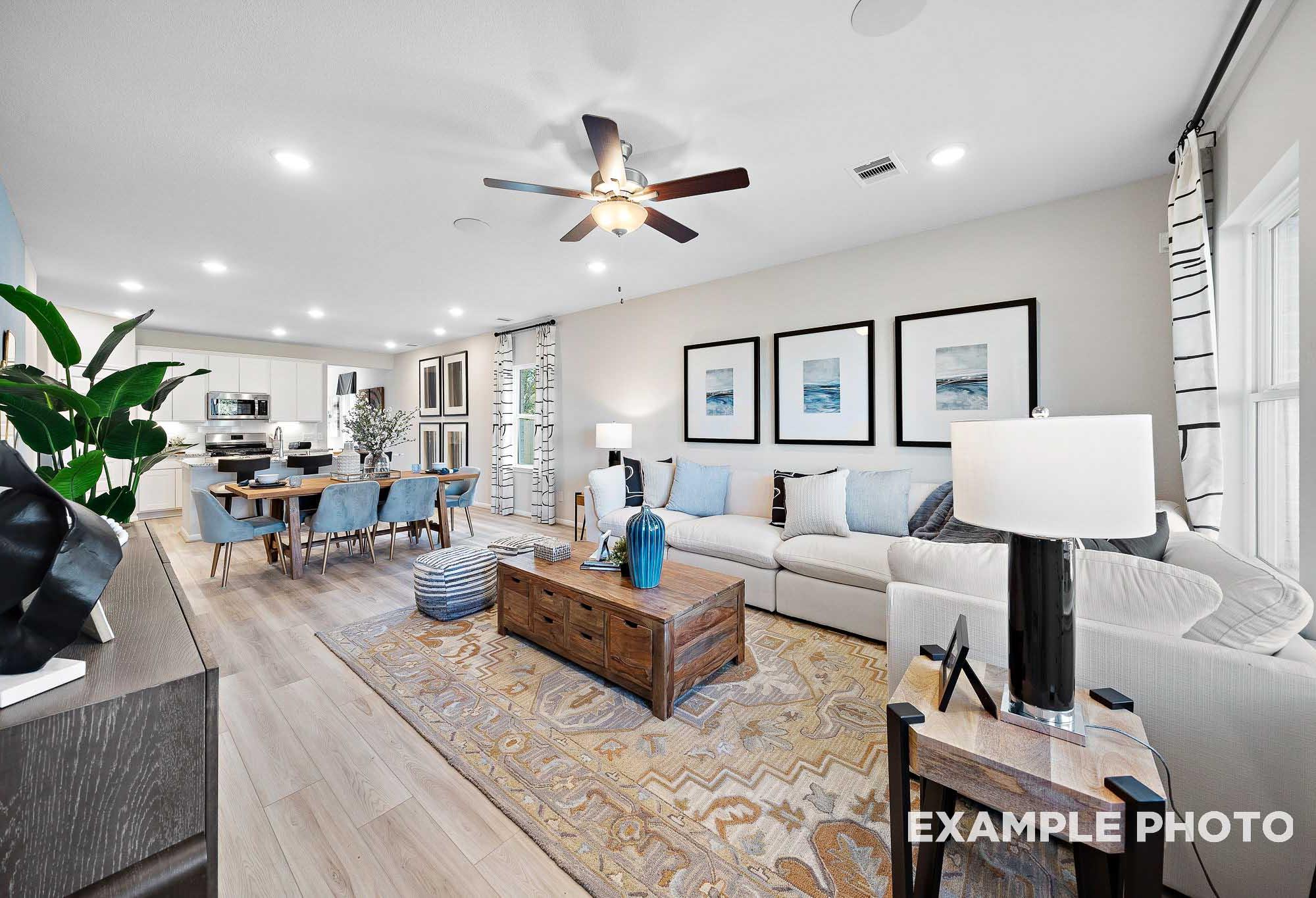 Spacious open-concept living and dining area in The San Marcos home with modern white sofa, wooden coffee table, and natural light