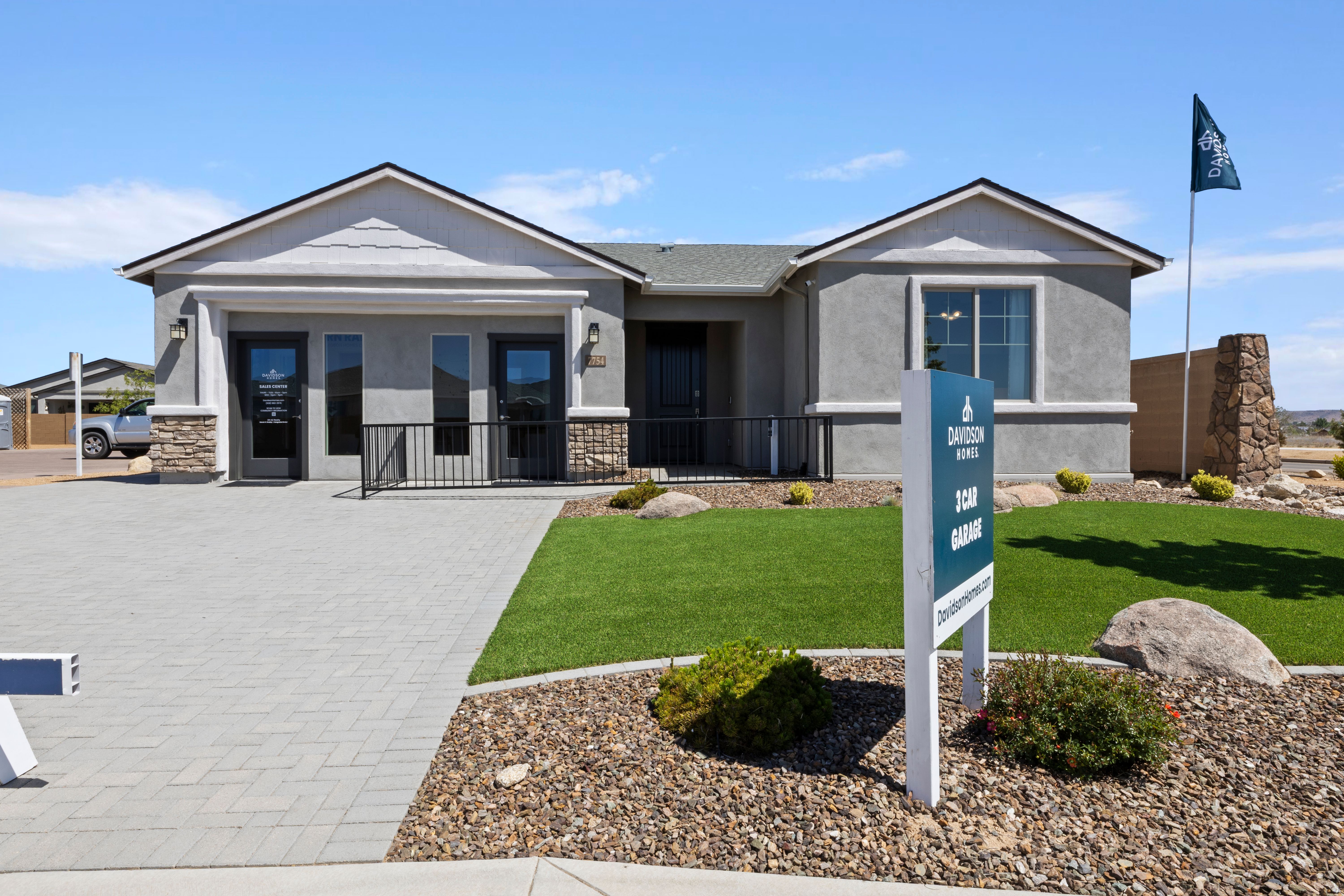 Davidson Homes sales center at North Ridge Pronghorn Ranch Prescott Valley AZ with modern stucco exterior, paver driveway, and desert landscaping