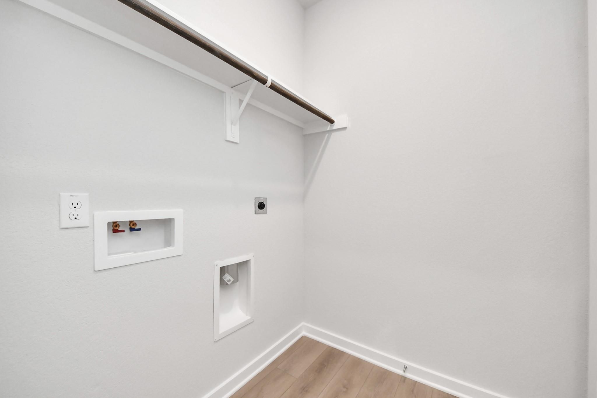 Dedicated laundry room with washer and dryer hookups in The Blanco E floor plan at Caney Creek Place, Conroe, Texas.