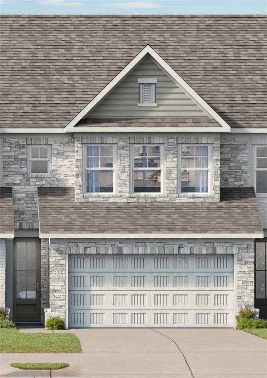 Modern 2-story Marion C home exterior featuring stone accents, white 2-car garage, and driveway in Lake Shore, Winder, Georgia by Davidson Homes