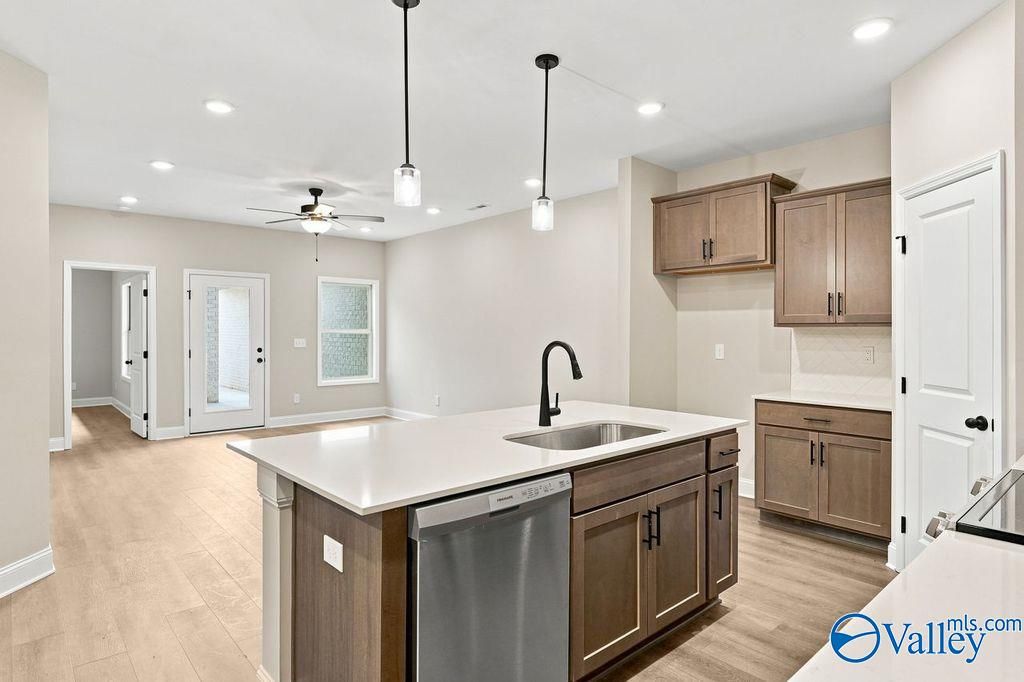 Modern open-concept kitchen with center island and pendant lighting in The Camilla C home at The Retreat at Cain Park.