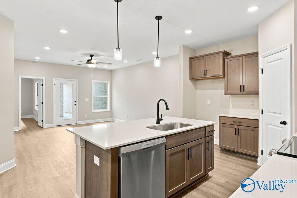 Modern open-concept kitchen with center island and pendant lighting in The Camilla C home at The Retreat at Cain Park.