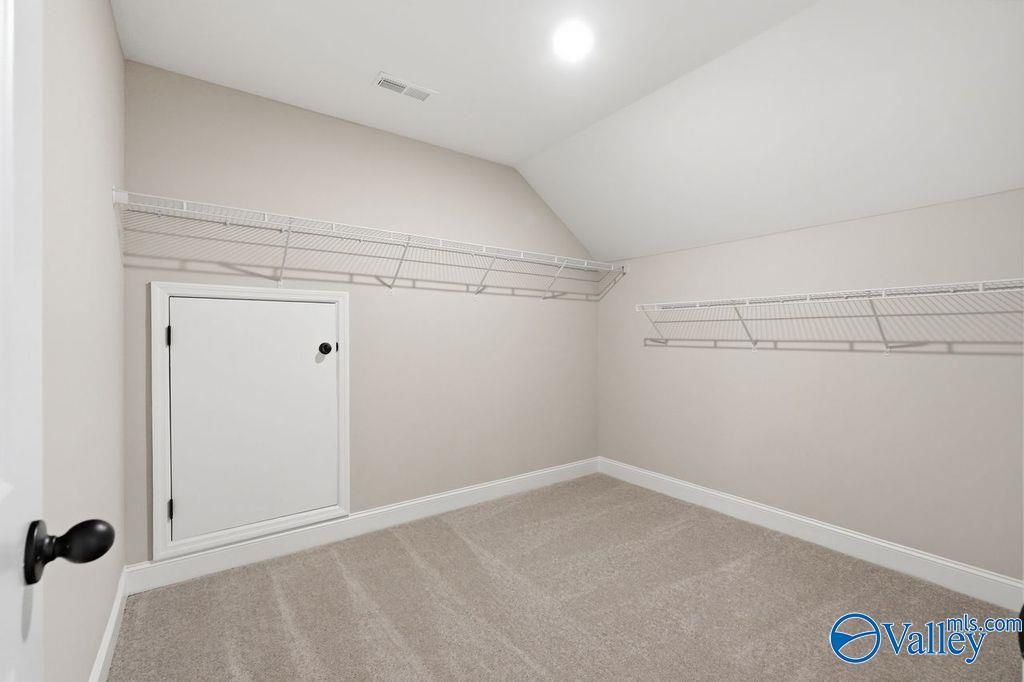 Walk-in closet with attic access door and wire shelving in The Rockford floor plan at Cain Park, Hartselle, Alabama.
