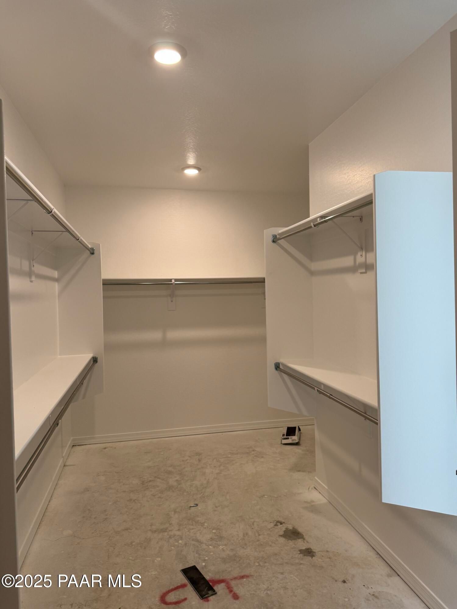 Spacious walk-in closet with built-in shelves and hanging rods in Davidson Homes The Sunrise II A, Prescott, Arizona