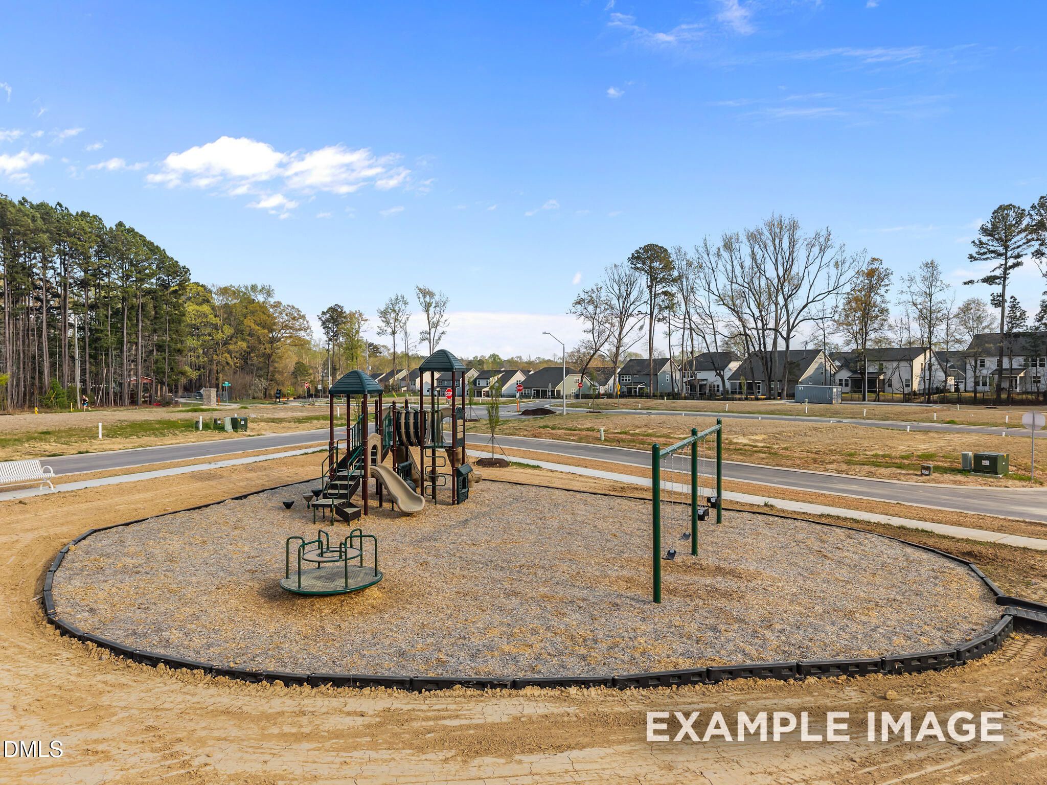 Children's playground with slides, swings, and merry-go-round in Camden Park, Knightdale, North Carolina