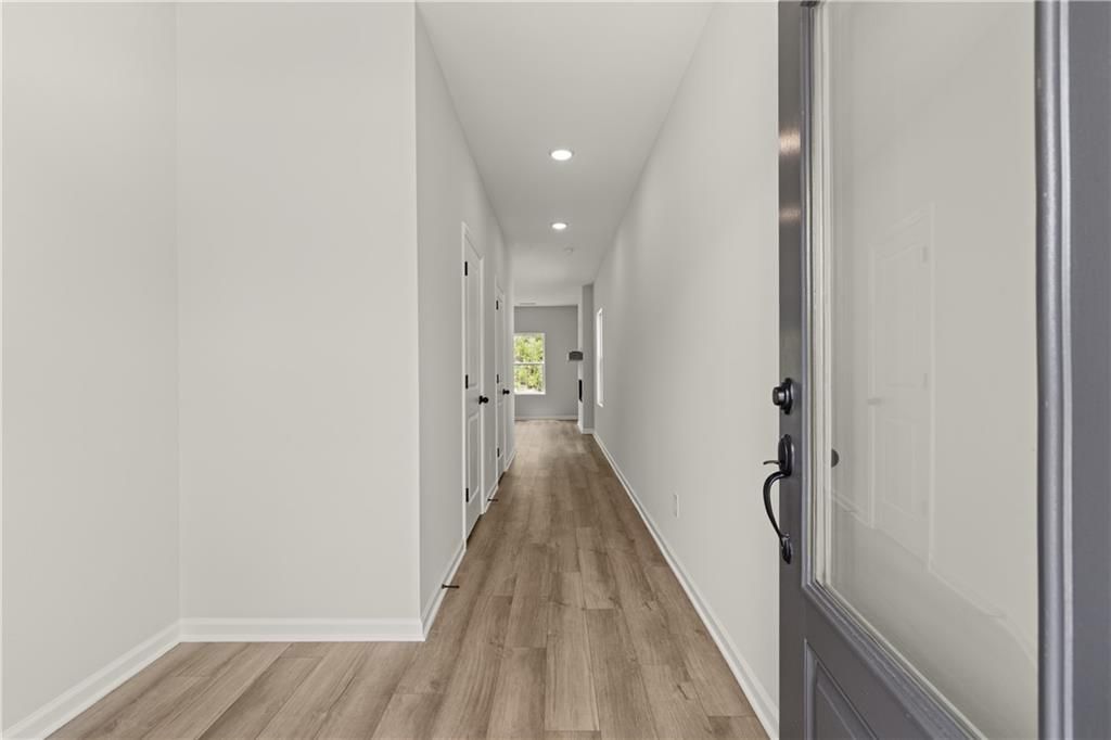 Bright foyer entrance with wood-look flooring in The Hartwell C floor plan at The Bluffs, Canton, Georgia.