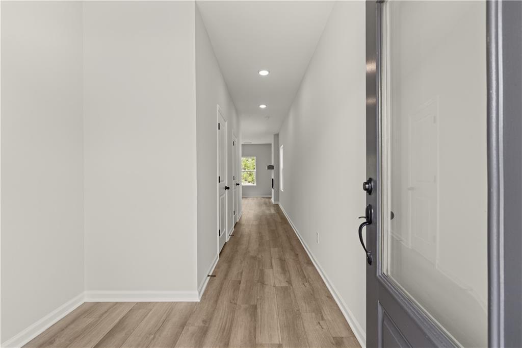 Bright foyer entrance with wood-look flooring in The Hartwell C floor plan at The Bluffs, Canton, Georgia.