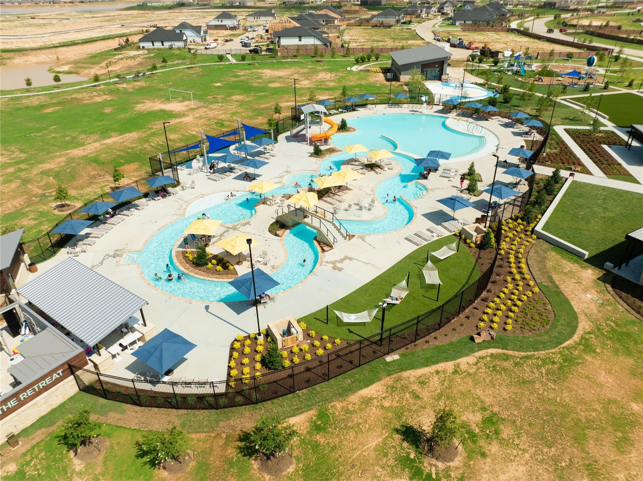 Aerial view of The Retreat resort-style pool and amenity center at Sunterra community in Katy, Texas.