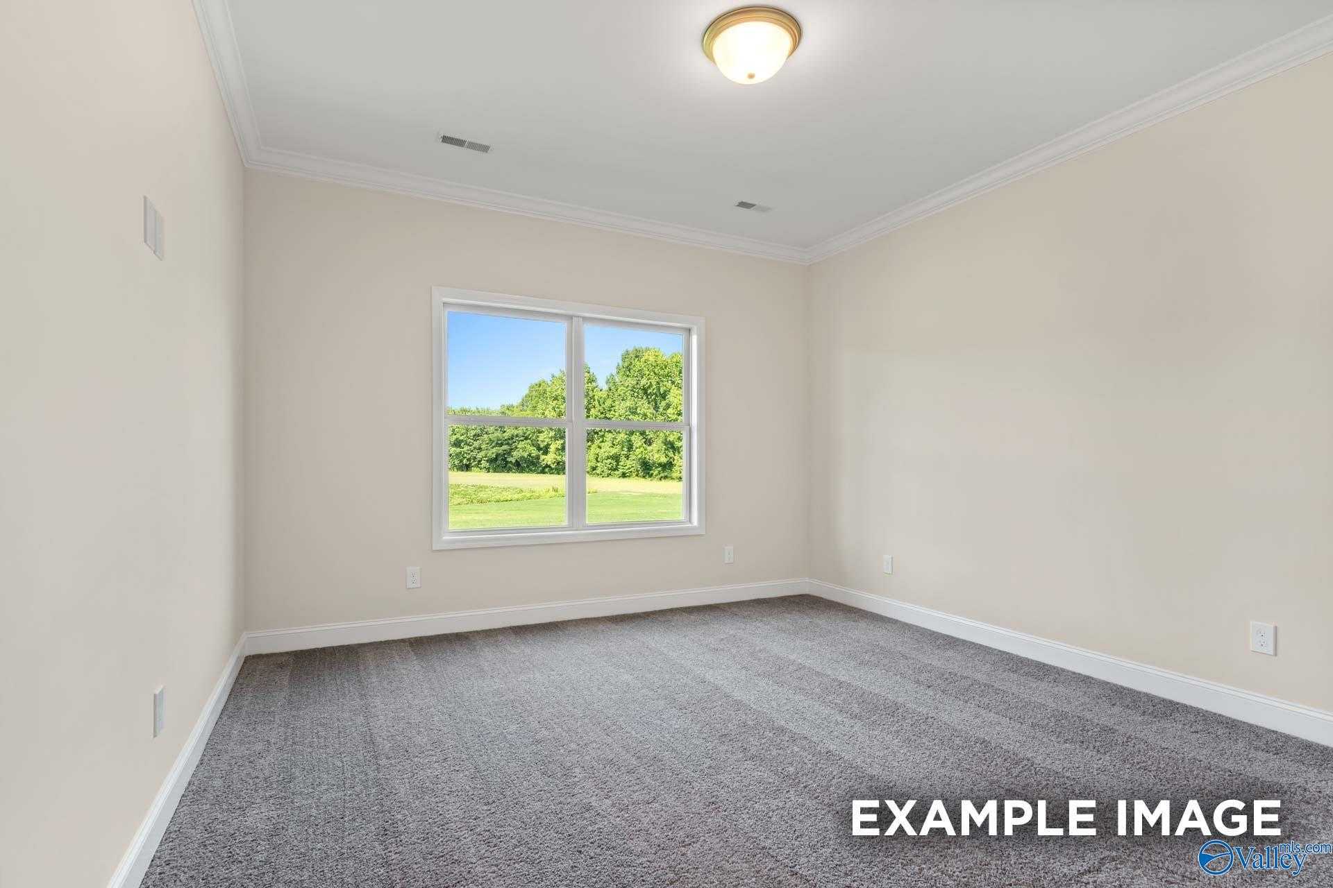 Bright bedroom with large window and scenic green field view in Davidson Homes The Asheville, Arab, Alabama